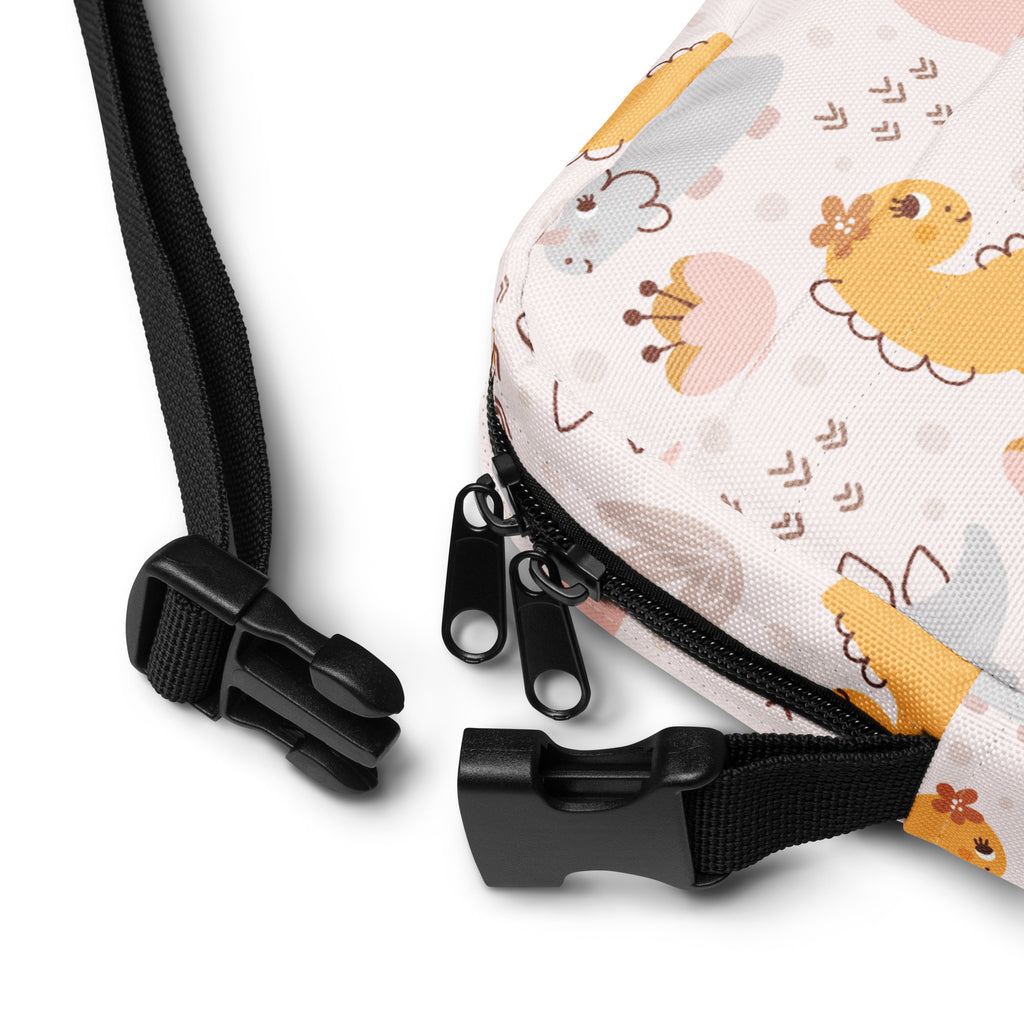 Girls floral dinosaur crossbody purse with soft pastel pattern and cute yellow gray dinosaurs on light fabric