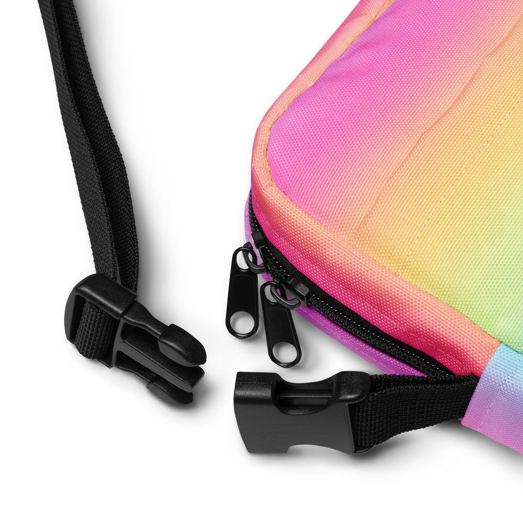Girls bright rainbow crossbody purse made of rainbow gradient fabric with black zipper pulls and adjustable straps