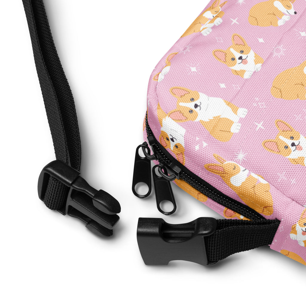 Girls pink corgi crossbody purse with black zippers and adjustable straps in a playful dog pattern design