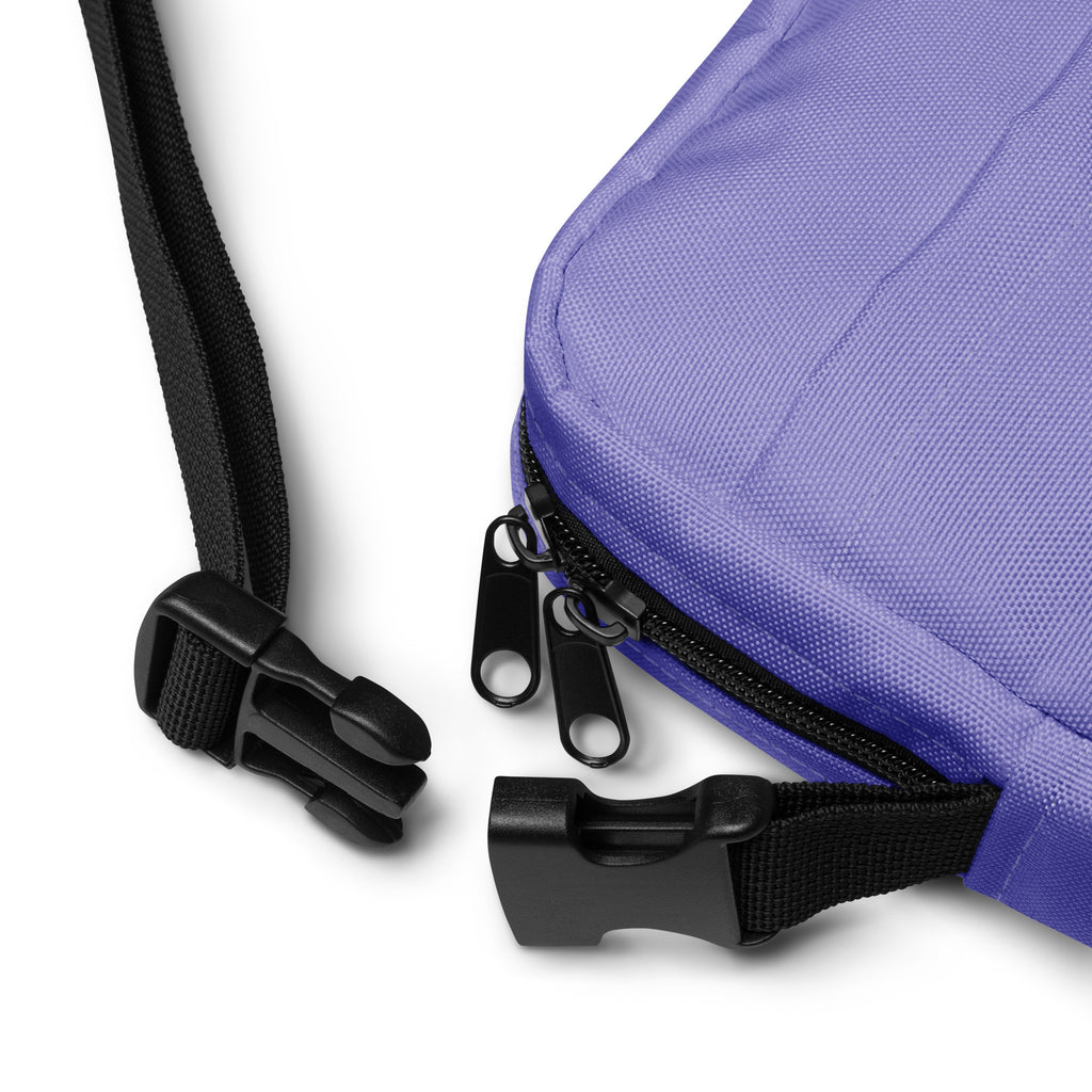 Girls purple crossbody purse made of fabric with black zipper pulls and adjustable strap clips for easy carrying