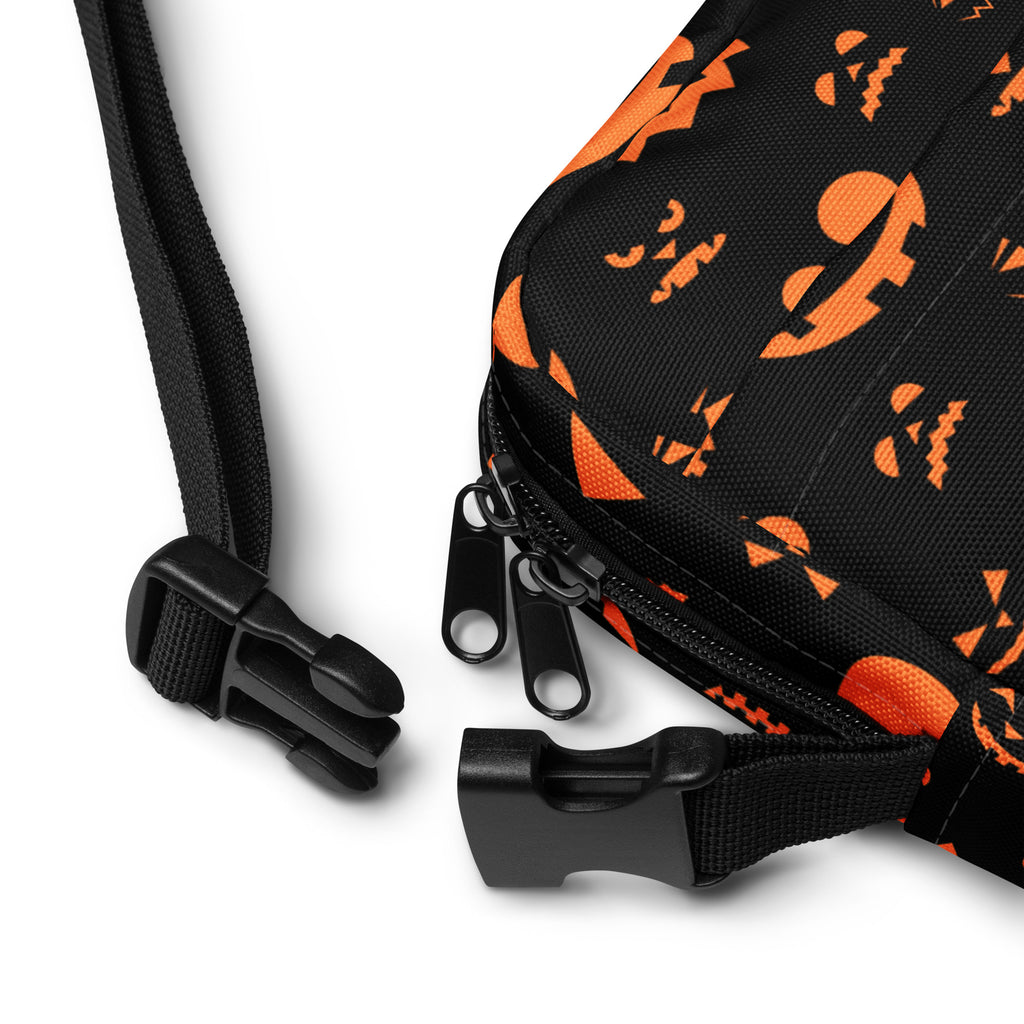 Black fabric girls crossbody bag with orange jack o lantern faces and bat patterns for halloween use