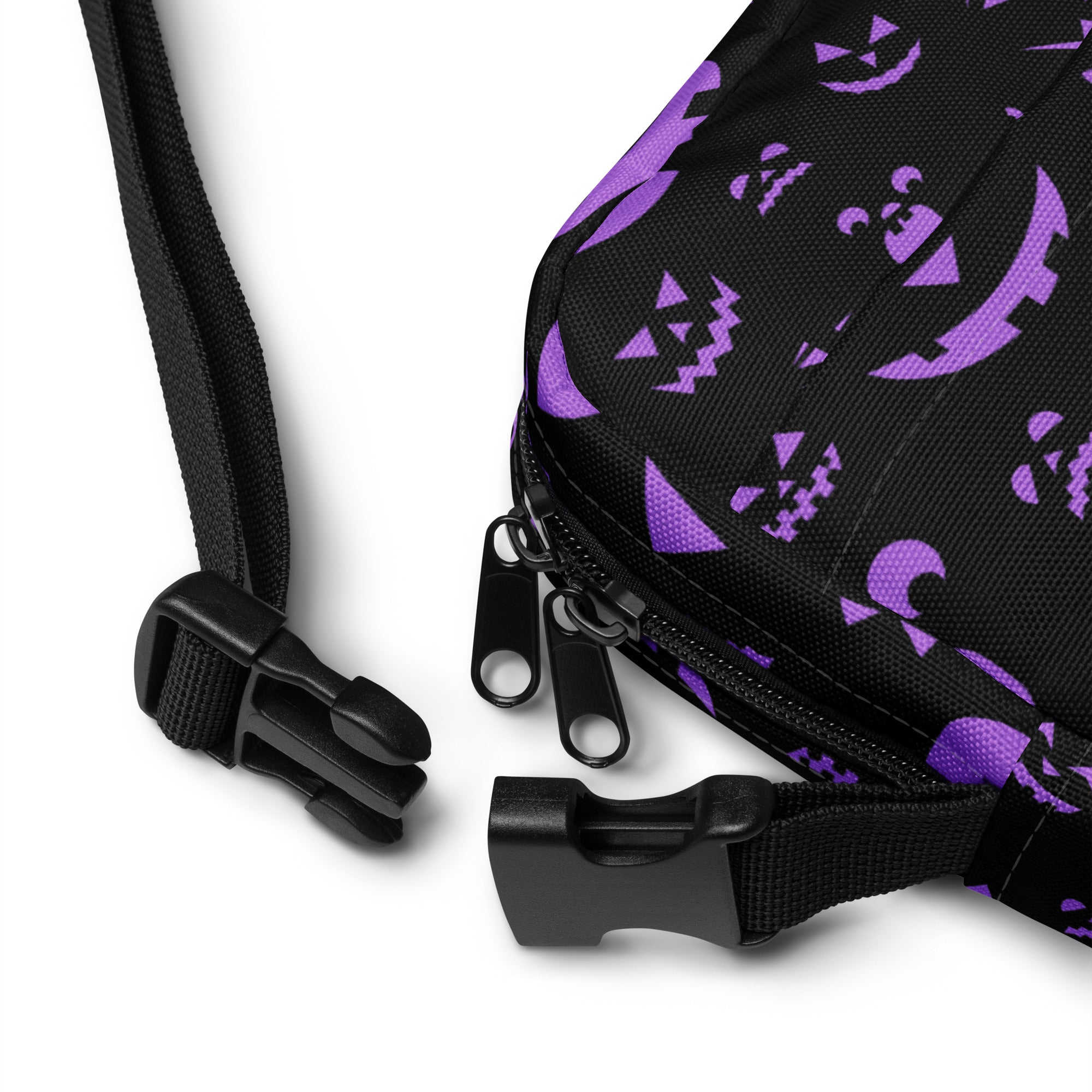Black fabric crossbody bag with purple halloween jack-o-lantern and moon patterns and adjustable strap buckles