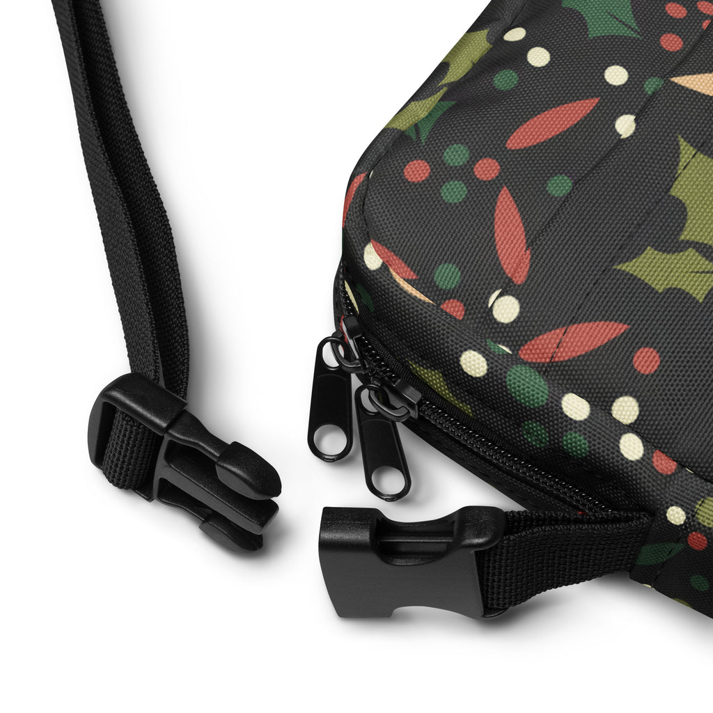 Girls christmas holly crossbody purse in black fabric with festive green red and cream holly and berry pattern