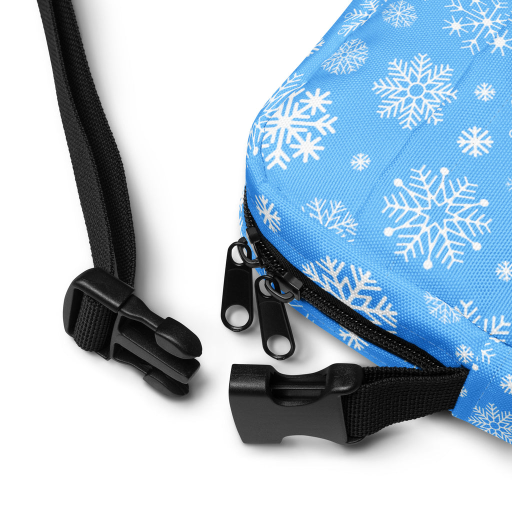 Blue snowflake-patterned winter fabric crossbody purse with black zipper and adjustable strap for women