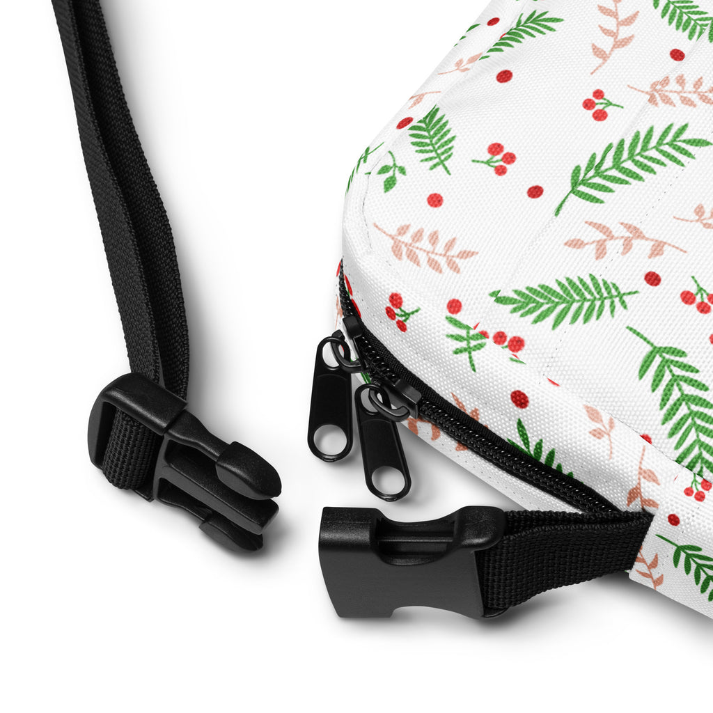White winter fern and berry Christmas women’s crossbody purse with festive green leaves pink stems and red berries pattern