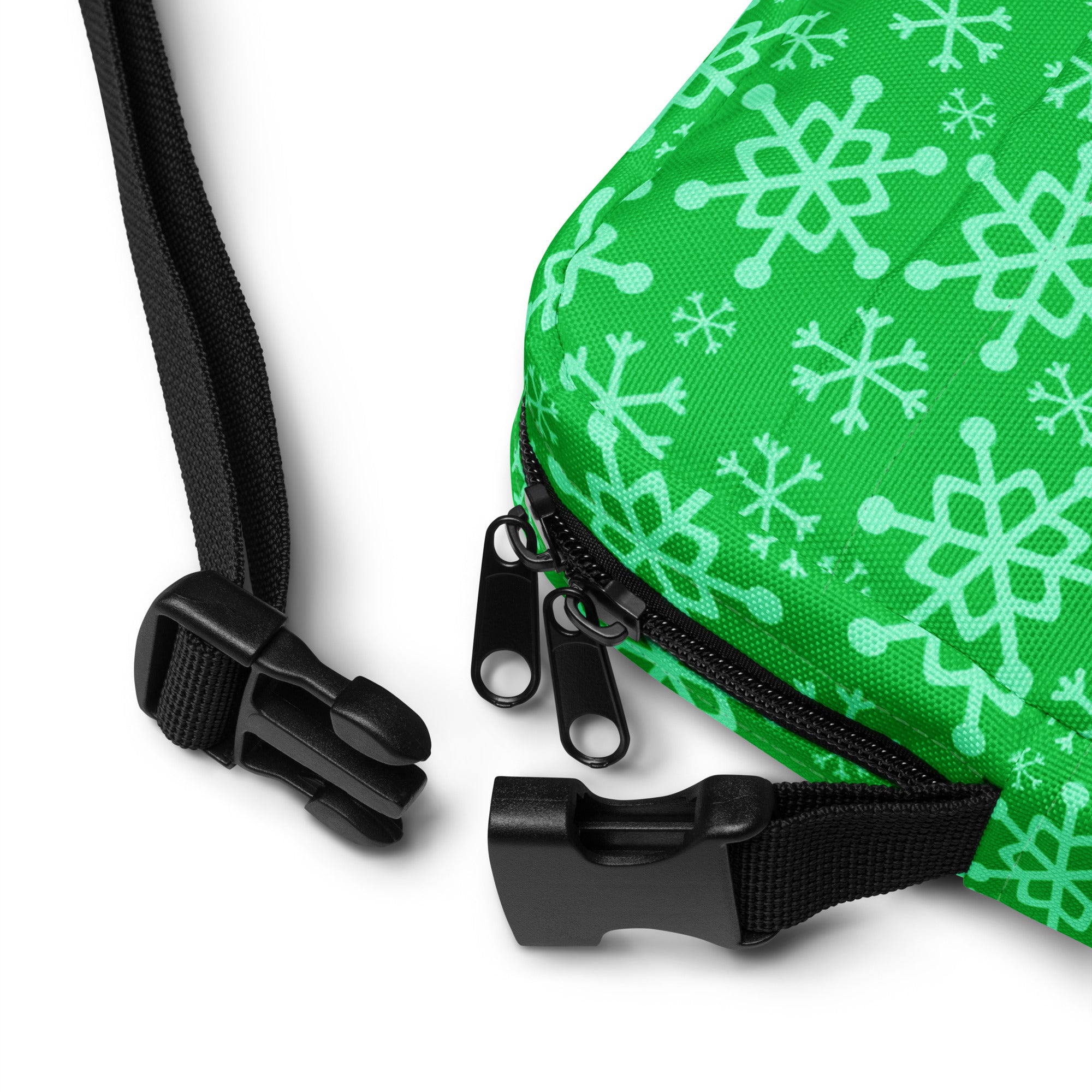 Girls green crossbody purse with vibrant fabric and light mint snowflake pattern featuring black zipper pulls