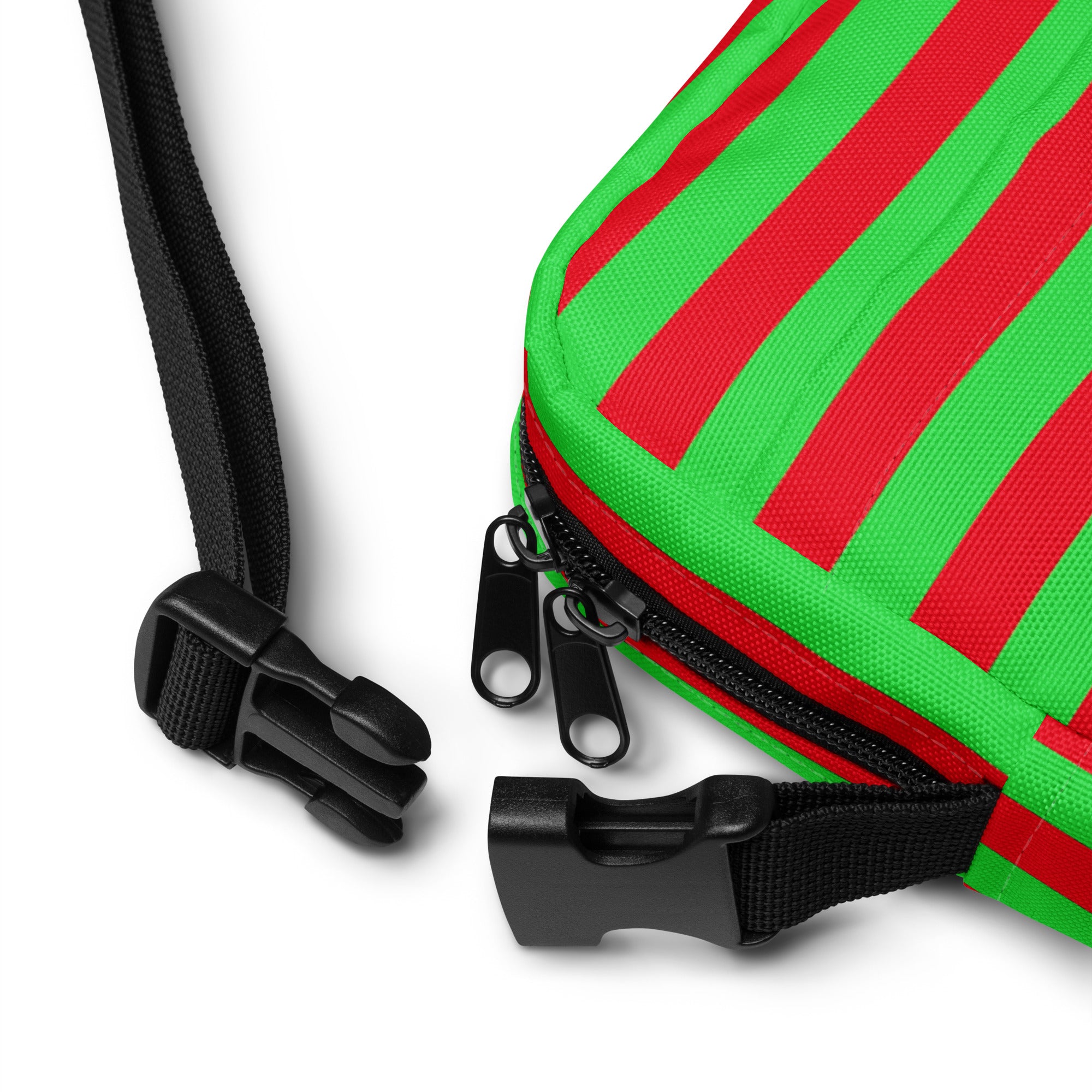 A vibrant red and green striped christmas crossbody purse with black zipper pulls and adjustable webbing straps