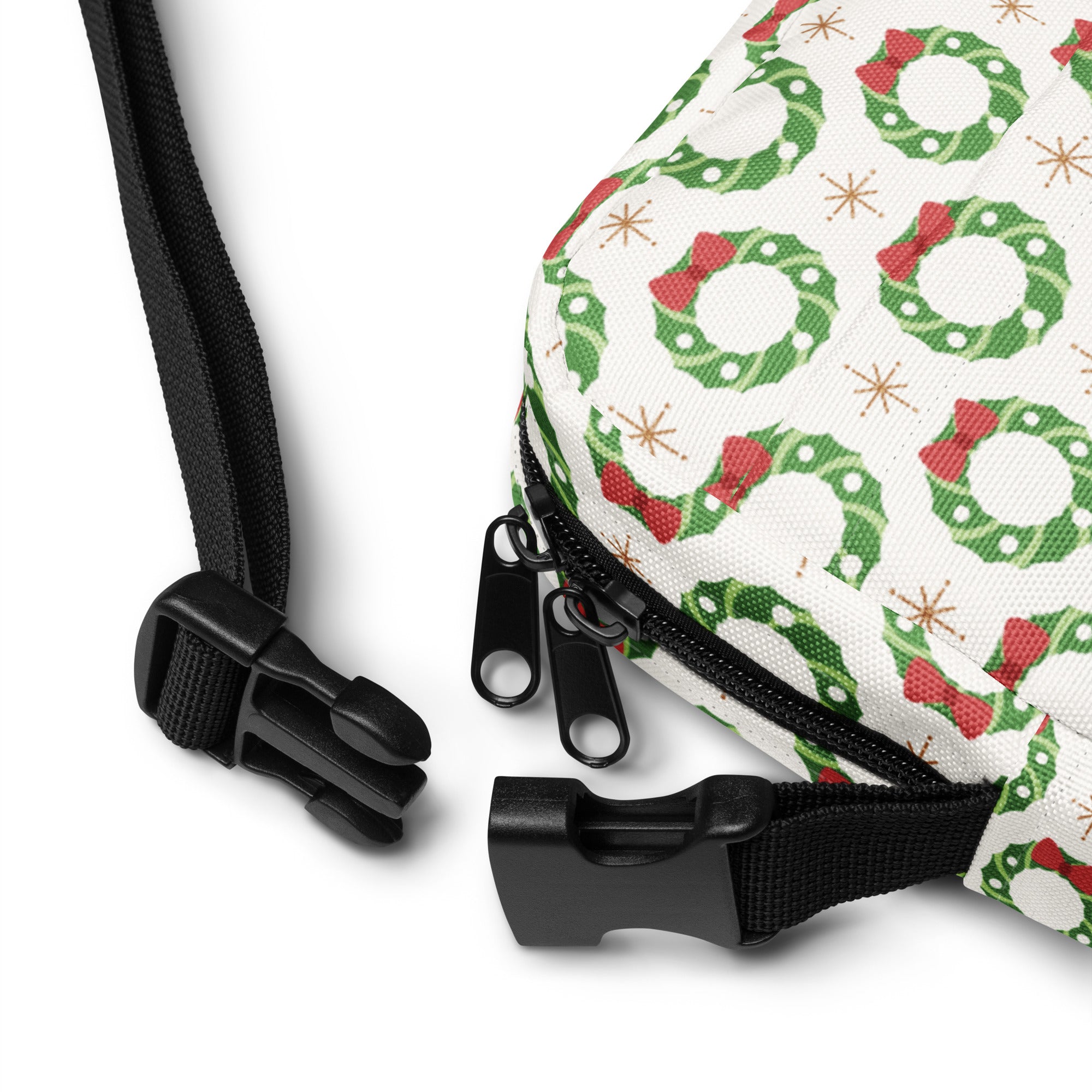 Girls christmas wreath crossbody purse featuring a white bag with green wreaths red bows and gold star accents