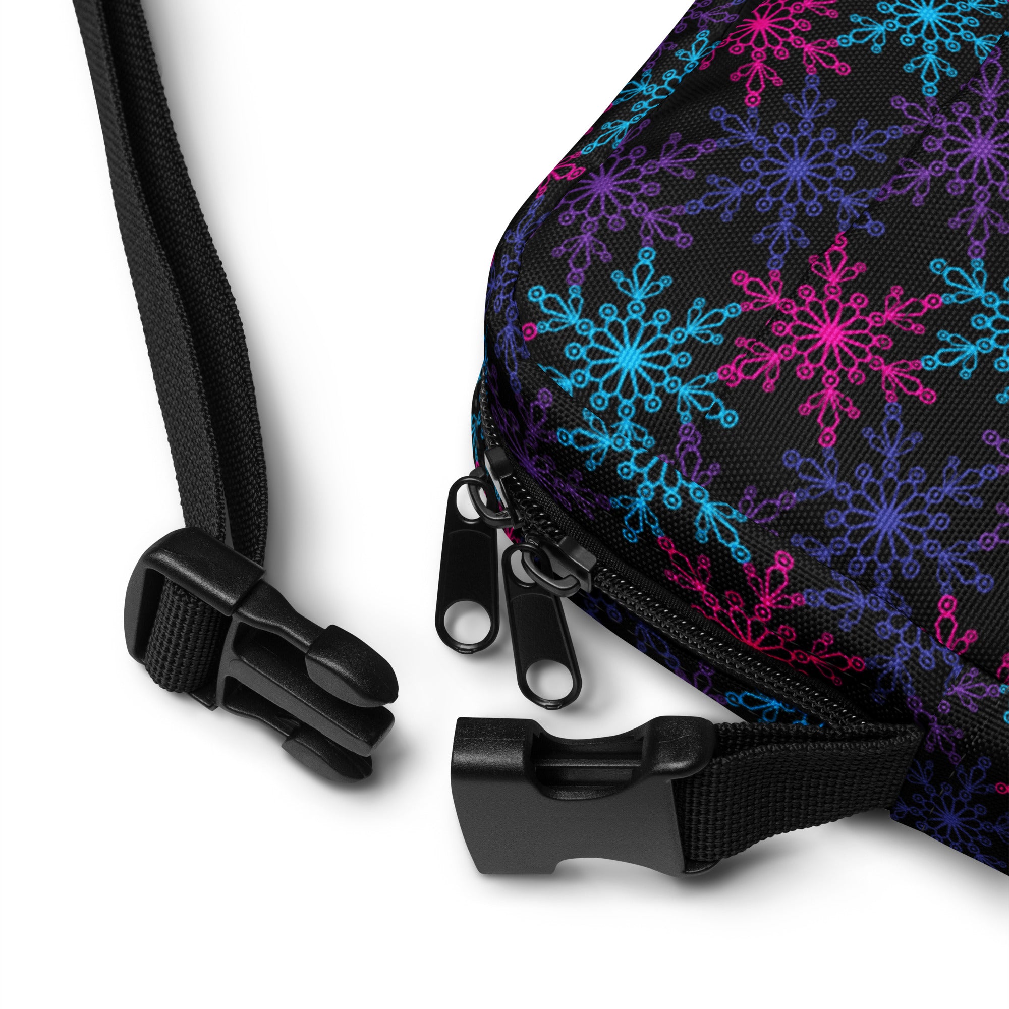 A black fabric girls neon snowflakes crossbody purse with a vibrant pattern of pink blue and purple snowflakes