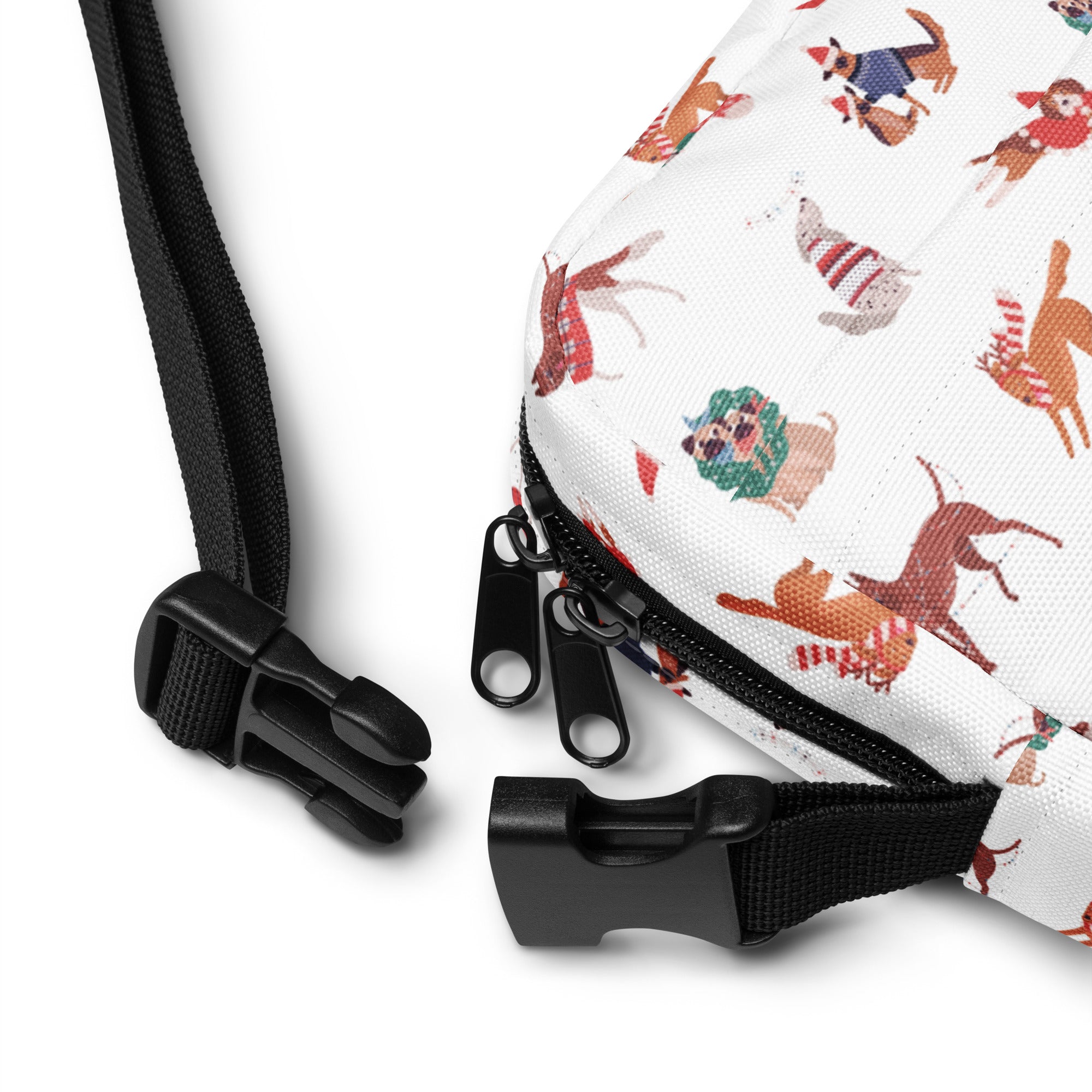 White crossbody bag with cartoon dogs in holiday attire featuring black zippers and adjustable black straps