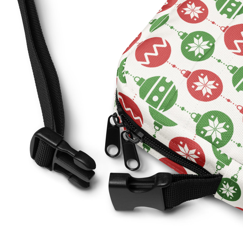 A festive white girls christmas ornaments crossbody purse with red and green ornament patterns and black adjustable straps