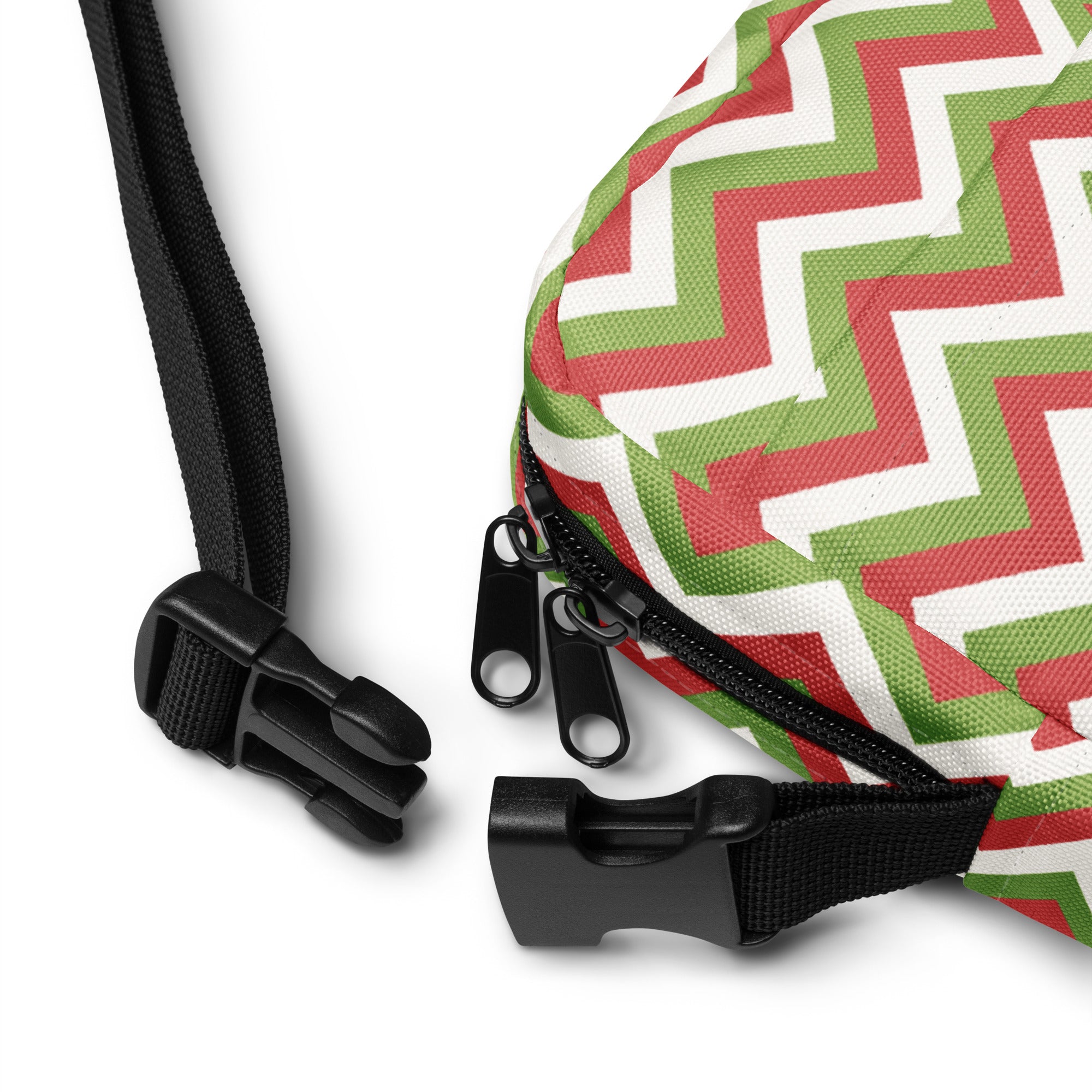 Christmas chevron women’s crossbody purse in red green and white zigzag fabric with black zipper pulls and adjustable straps
