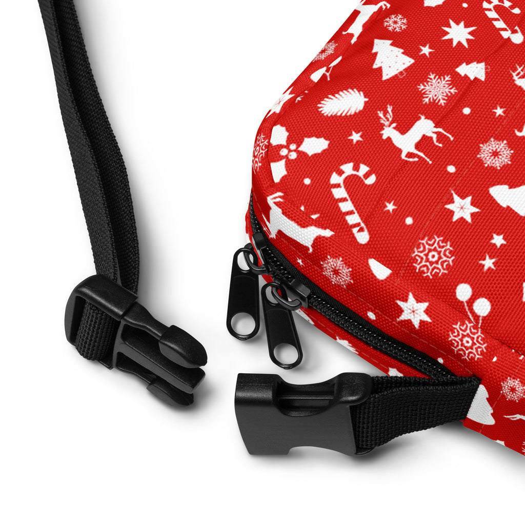 Red christmas womens crossbody purse featuring a red bag with white holiday patterns and black zipper pulls