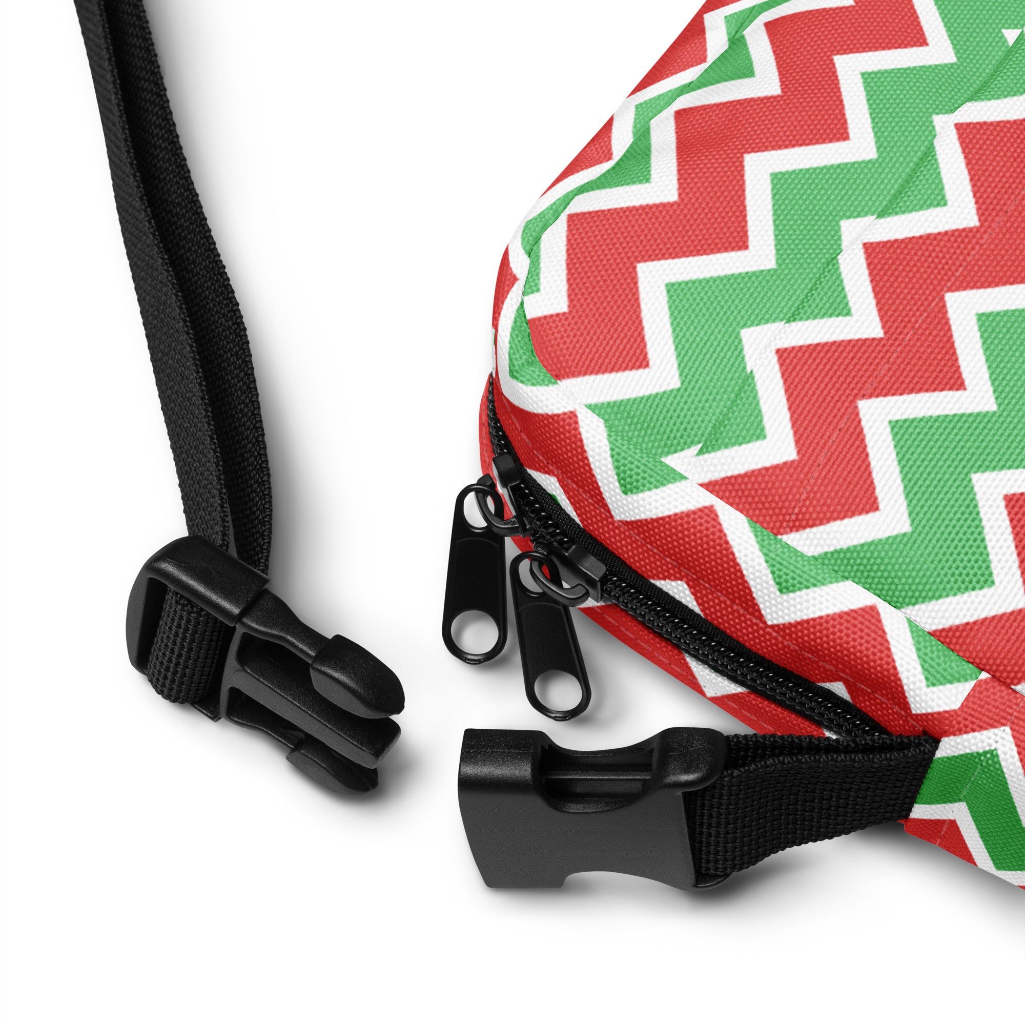 Girls red and green chevron crossbody purse made of zigzag-patterned fabric with black zipper pulls and adjustable strap