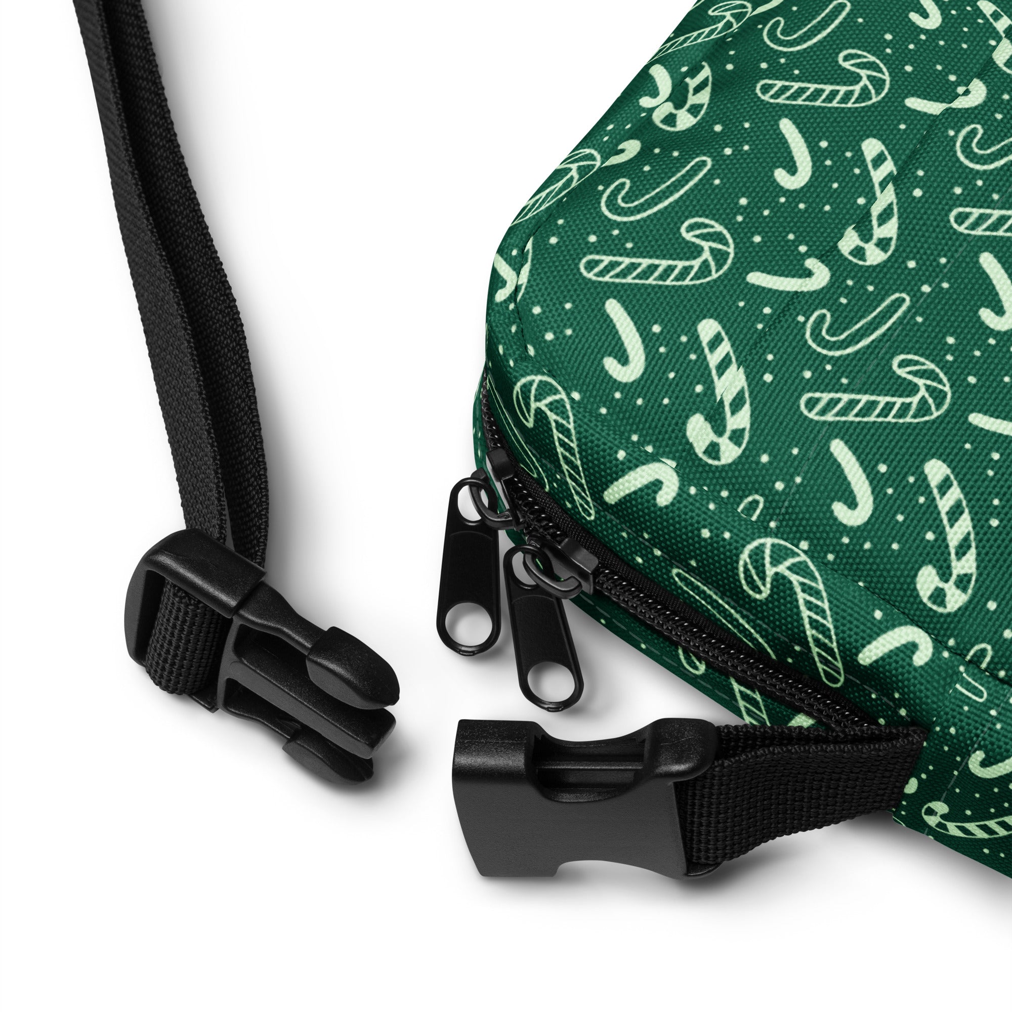 Green candy cane patterned drawstring crossbody purse with black zipper pulls and adjustable straps for women