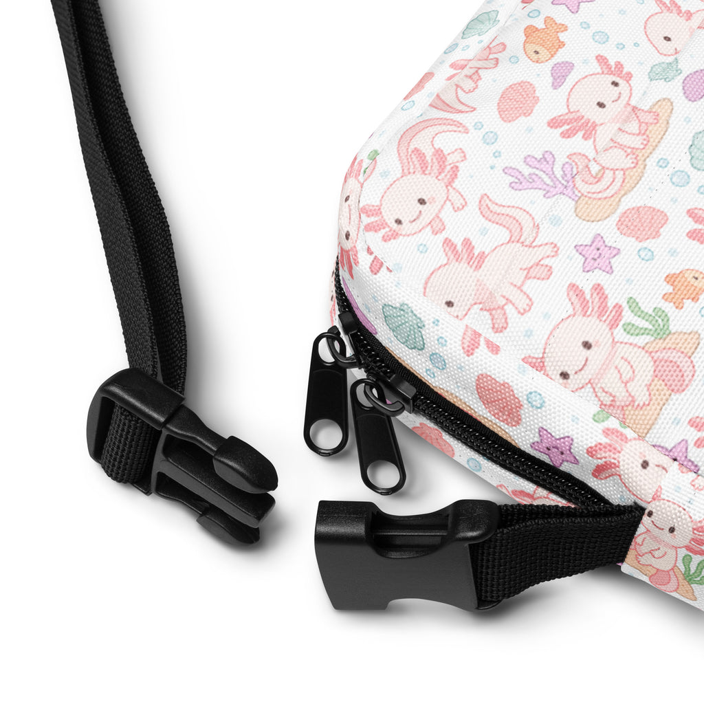 A white canvas girls axolotl crossbody purse with pastel pink and peach axolotl and seashell pattern