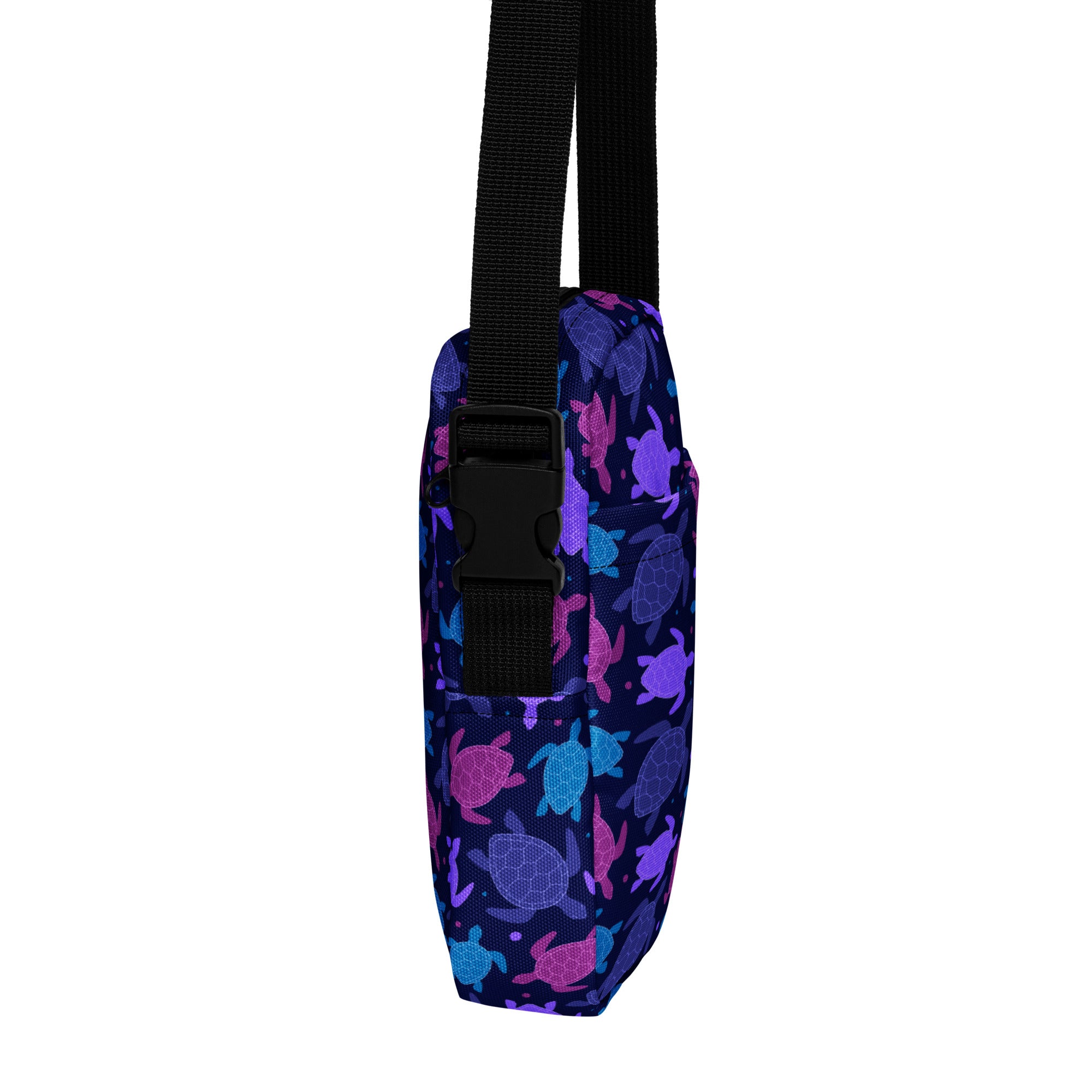 A navy blue fabric girls crossbody purse with pink purple and teal sea turtles vibrant pattern