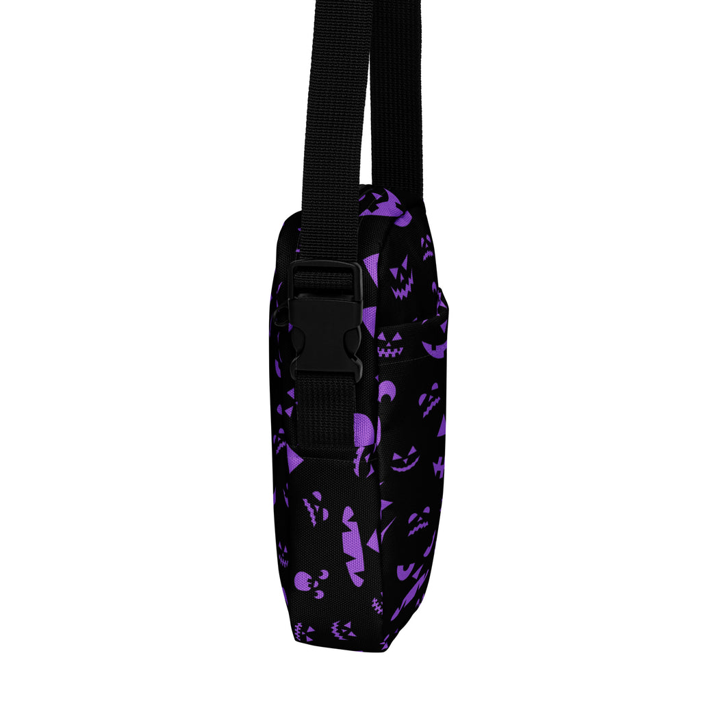 Black crossbody bag with purple jack-o-lantern and skull patterns and black adjustable strap for girls Halloween use