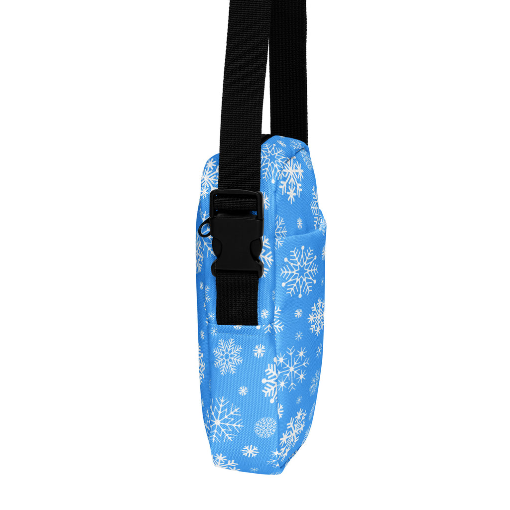 Girls blue snowflake crossbody purse with black adjustable strap and buckle made of patterned fabric