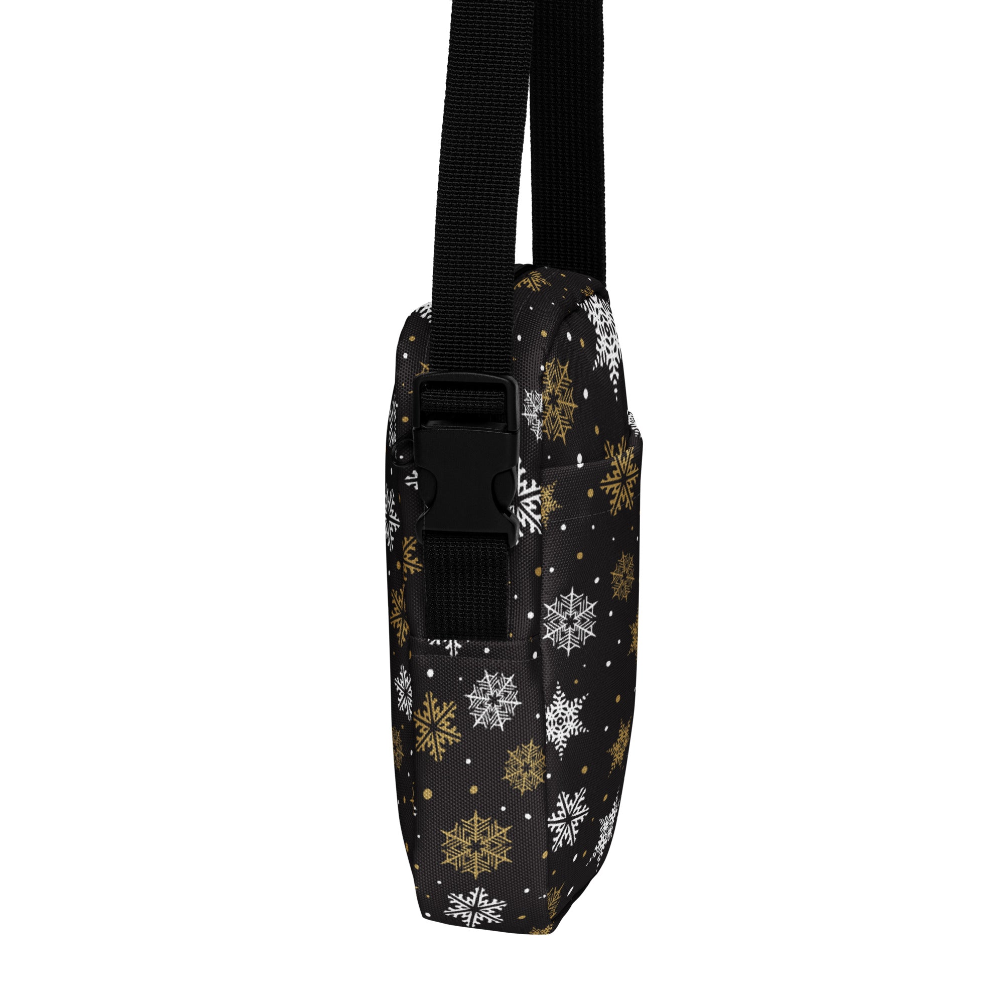 Girls black crossbody purse with festive white and gold snowflake pattern and adjustable black strap