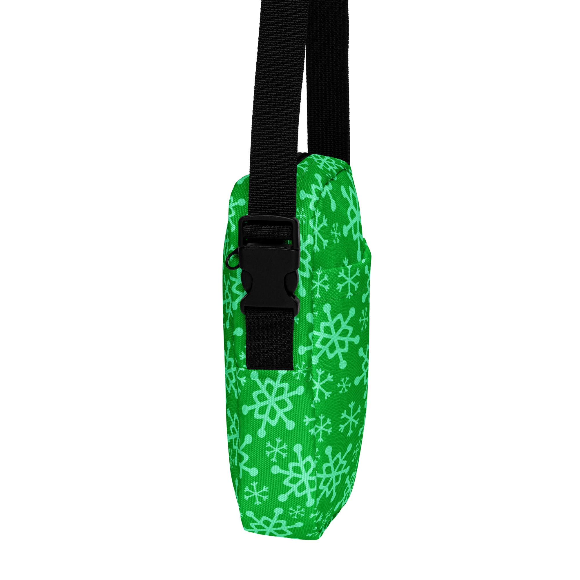 Bright green girls crossbody purse with white snowflake pattern and black adjustable strap for winter use