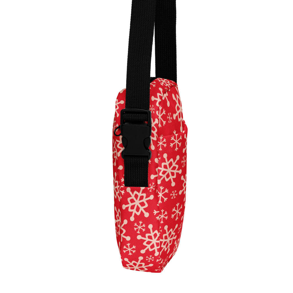 Red snowflake christmas women’s crossbody purse made of red fabric with white snowflake pattern and black adjustable strap