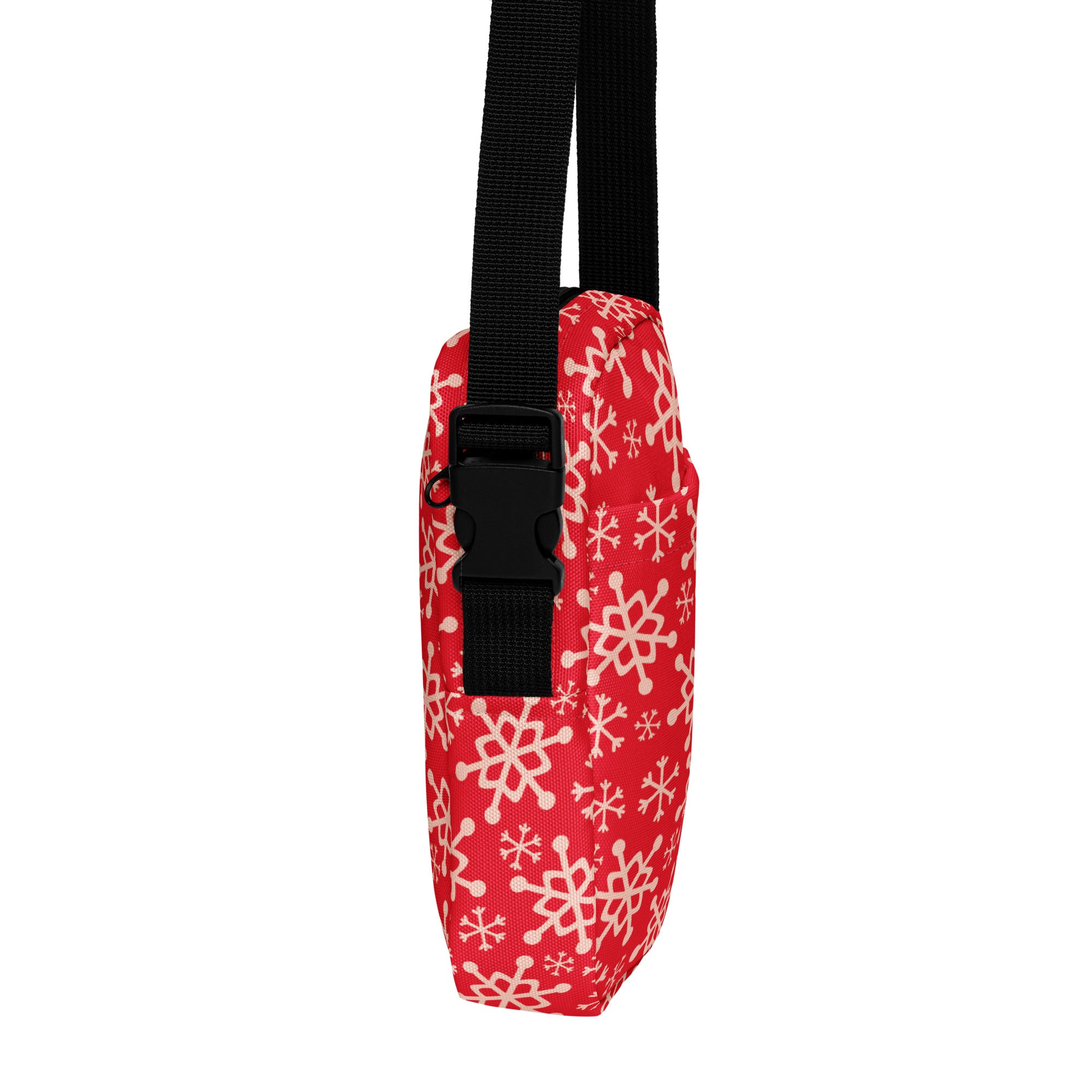 Red snowflake christmas women’s crossbody purse made of red fabric with white snowflake pattern and black adjustable strap