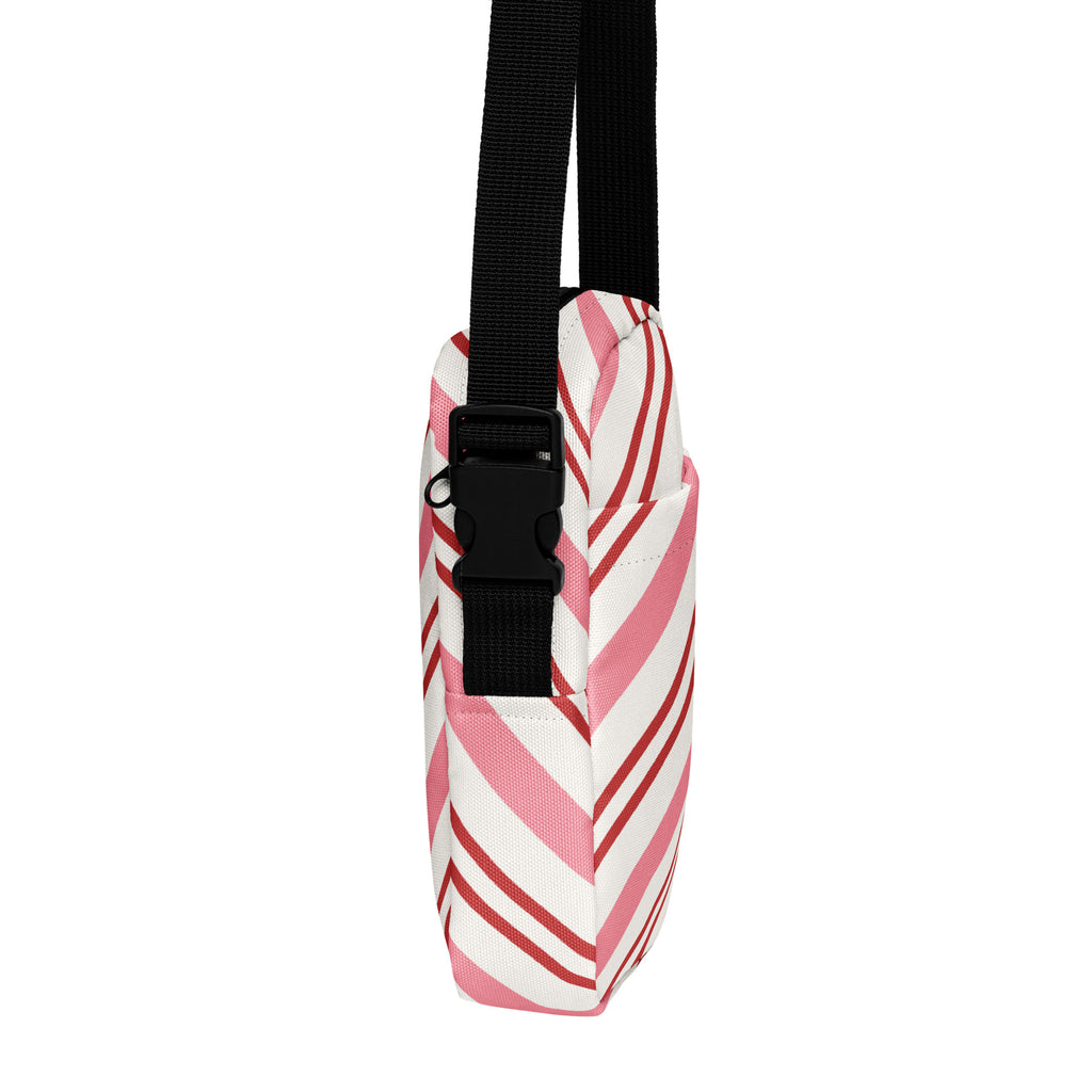 Pink candy cane stripe christmas women’s crossbody purse with pink and white striped canvas and black adjustable strap