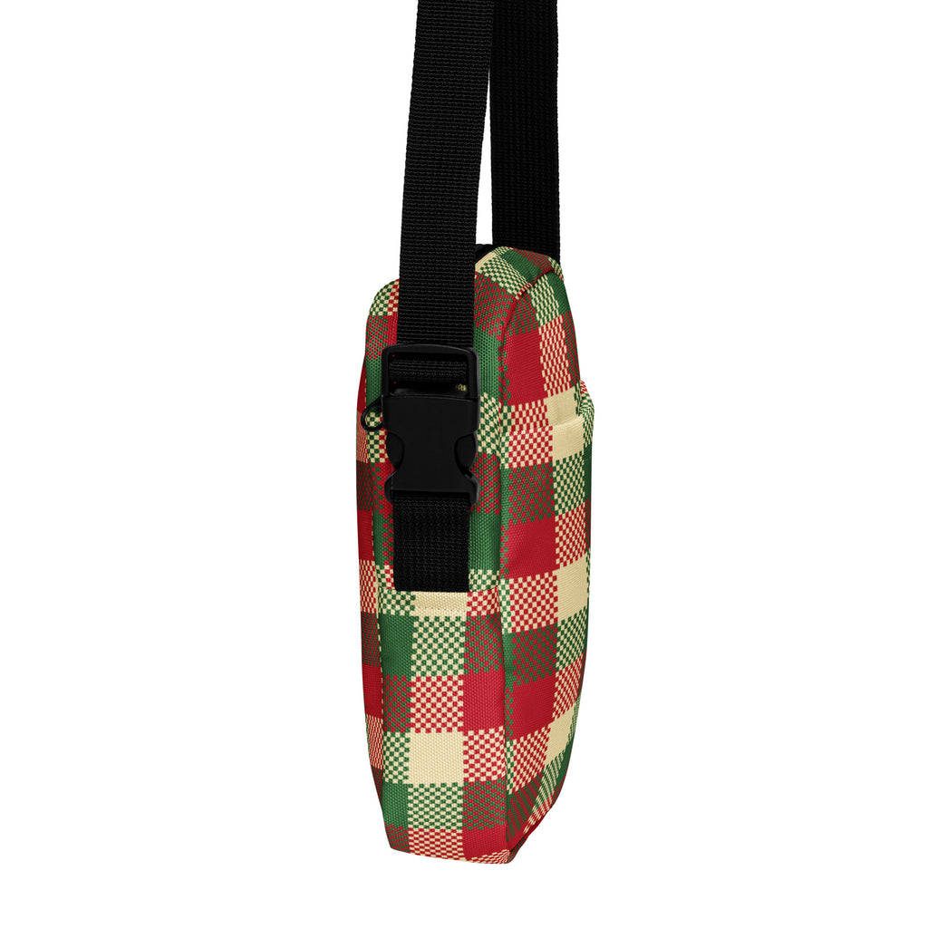 A festive red green and cream plaid winter women’s crossbody purse with black adjustable strap and crossbody design