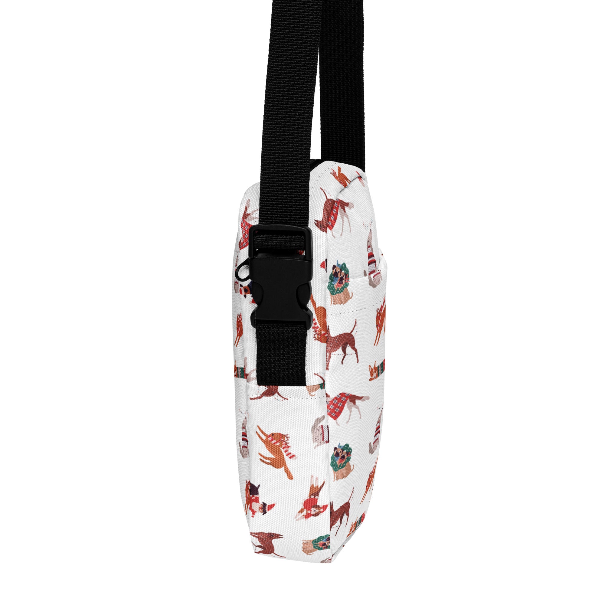 White crossbody bag with playful red and brown dogs in festive holiday attire and black adjustable strap for girls