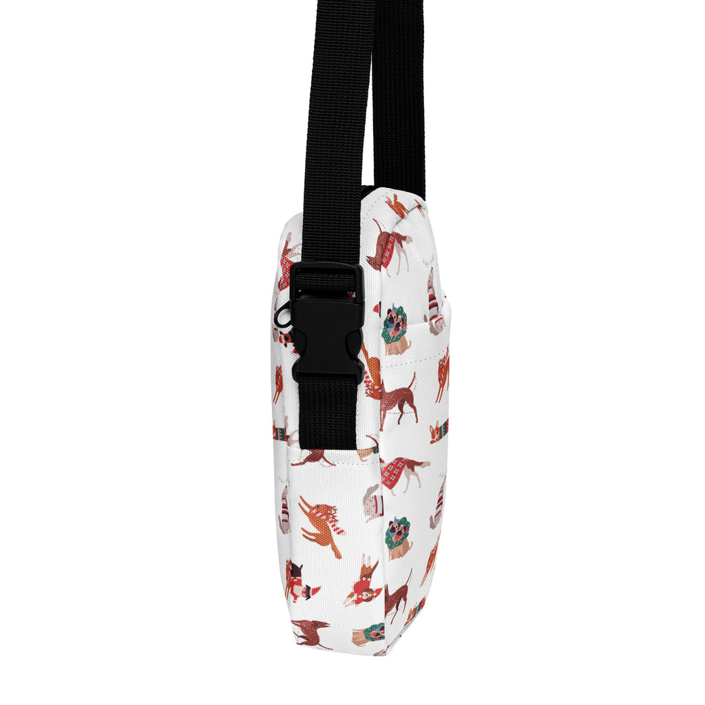 White crossbody bag with festive red and brown dogs pattern and black adjustable strap for christmas use