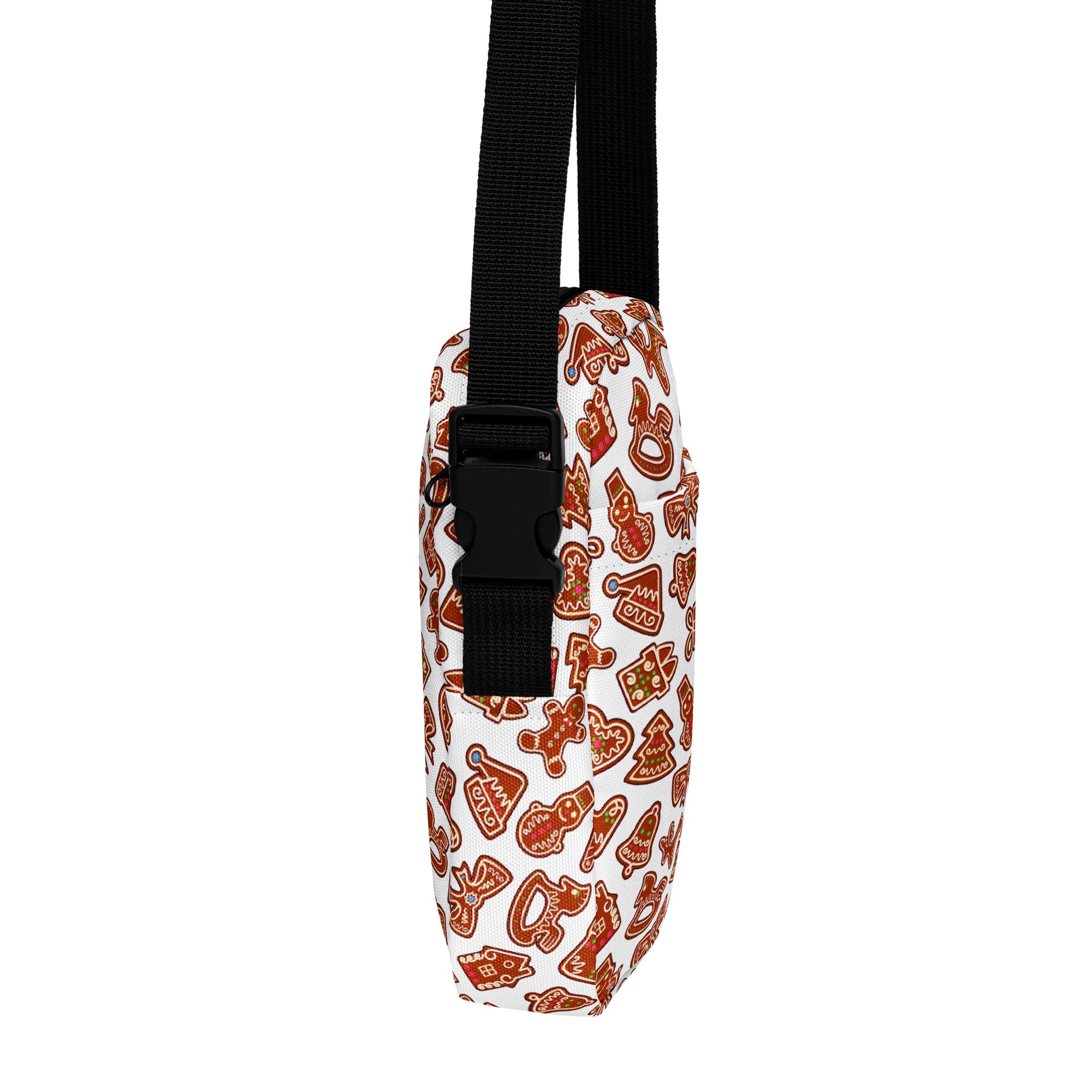 A white crossbody bag with orange gingerbread cookie pattern and black straps for holiday use