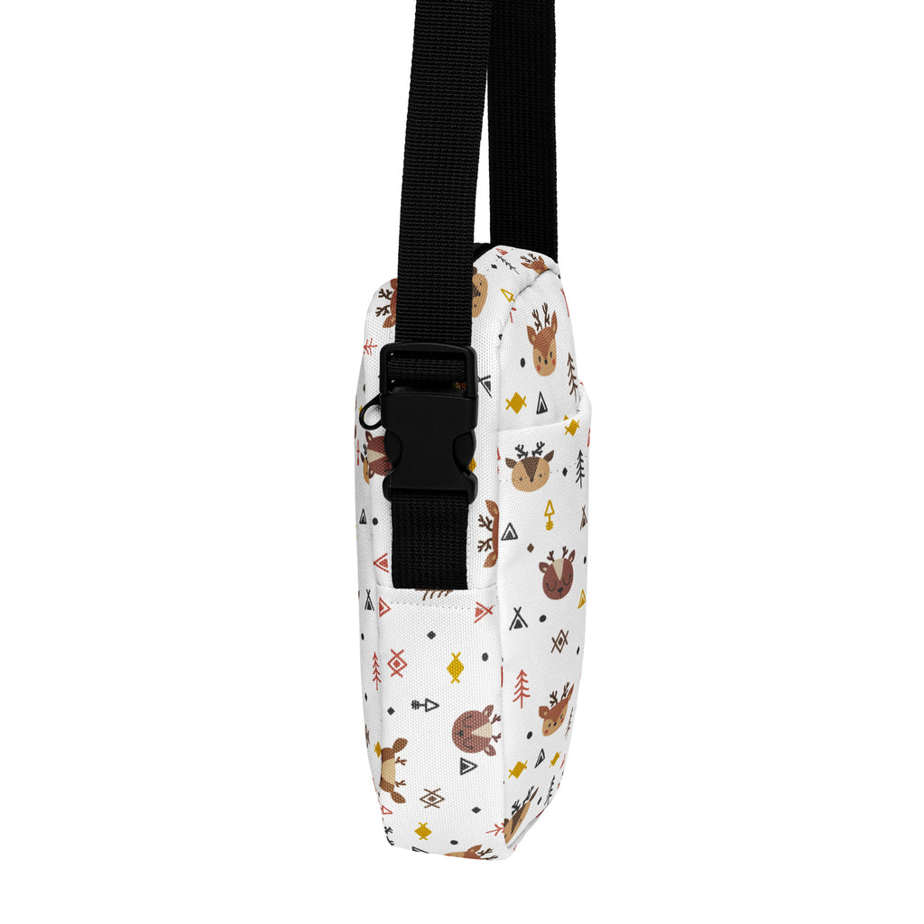 White canvas crossbody bag with playful brown reindeer pattern geometric shapes and tiny trees in earthy tones