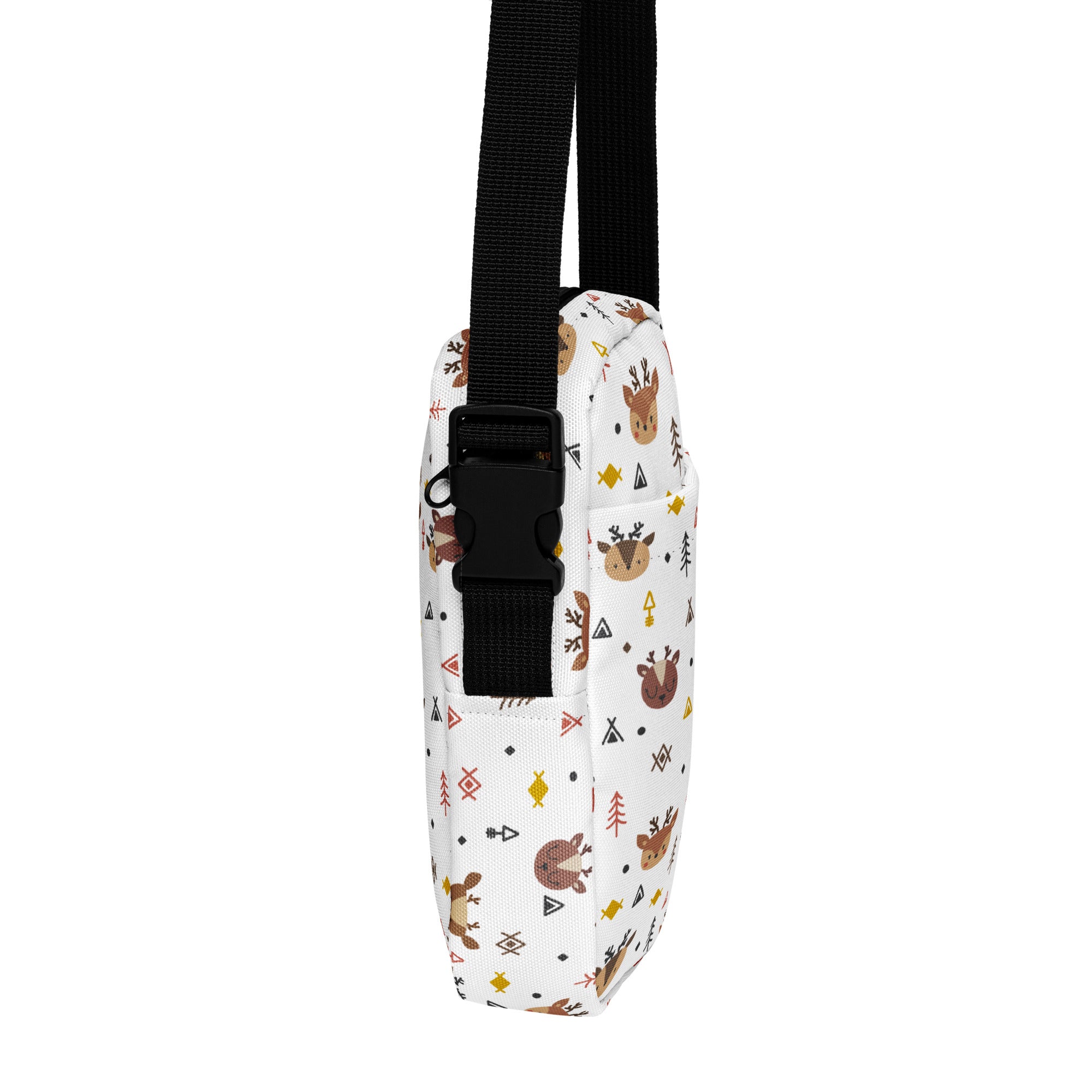 White canvas crossbody bag with playful brown reindeer pattern geometric shapes and tiny trees in earthy tones