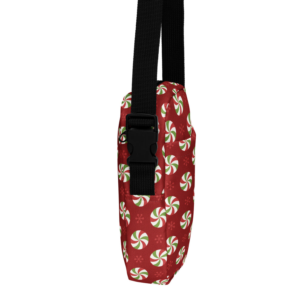 Red fabric peppermint swirl christmas women’s crossbody purse with snowflake pattern and black adjustable strap