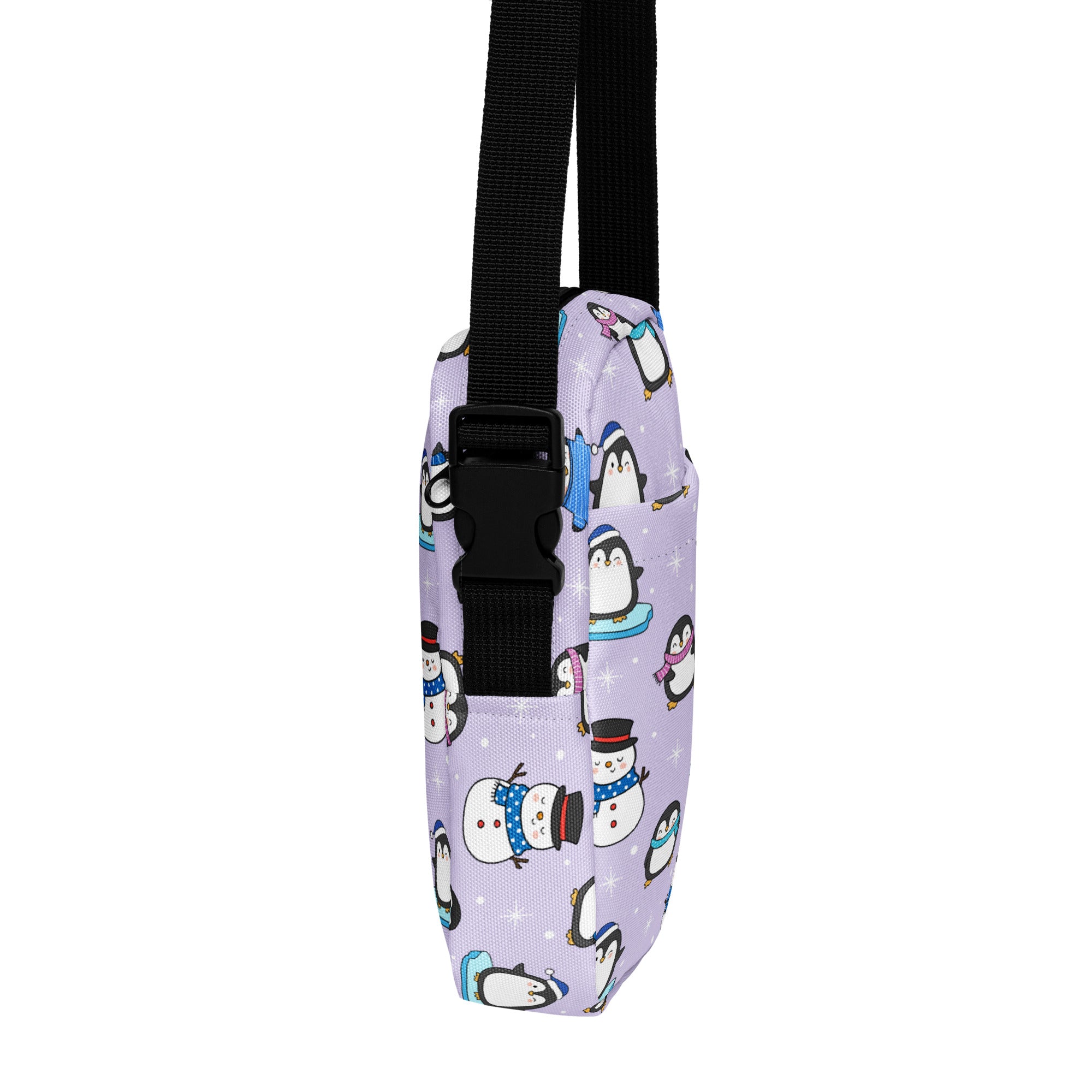 Girls winter penguin crossbody purse in lavender fabric with cartoon penguin and snowman pattern and black adjustable strap