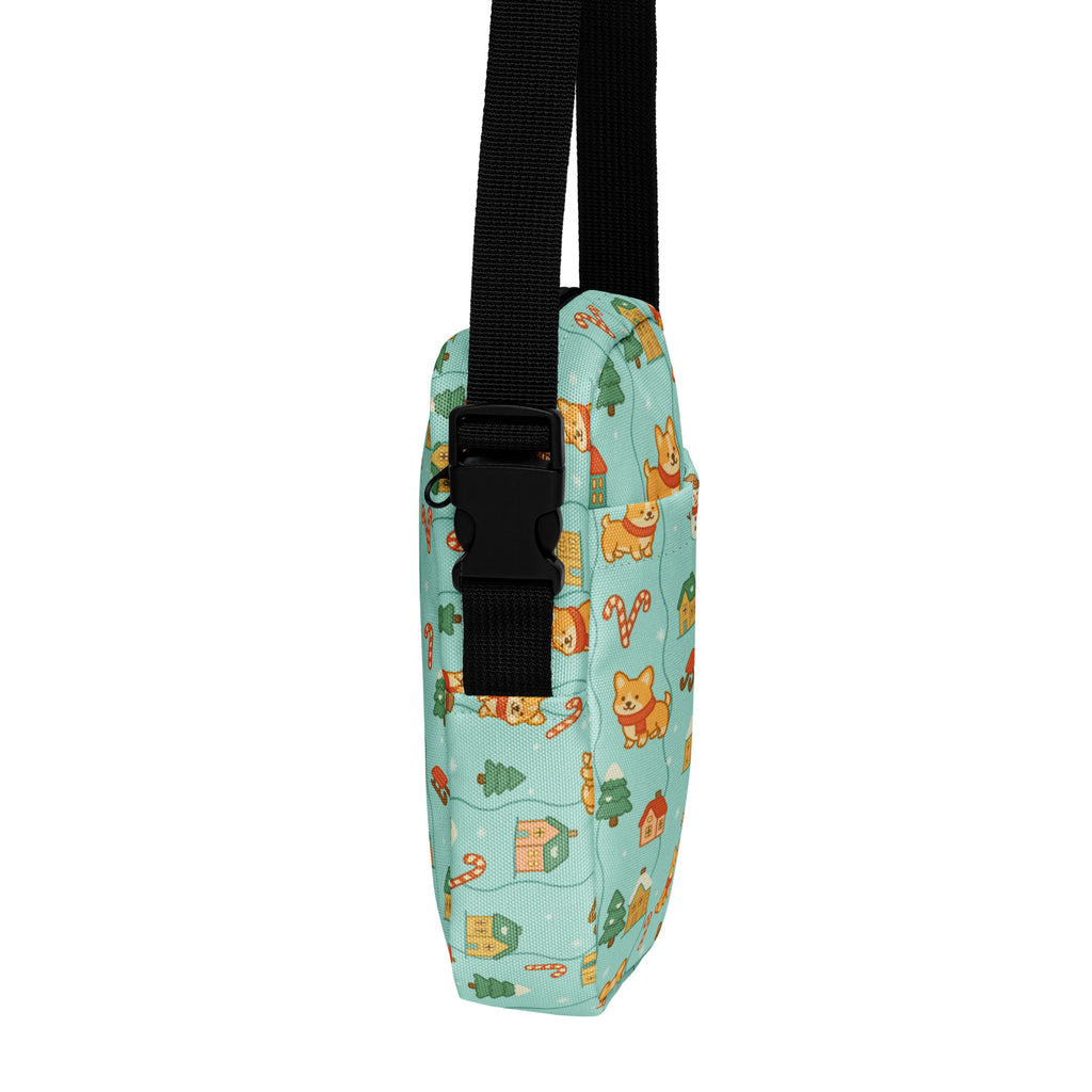 A light blue fabric Shiba Inu Christmas women’s crossbody purse with orange corgis candy canes and christmas trees pattern