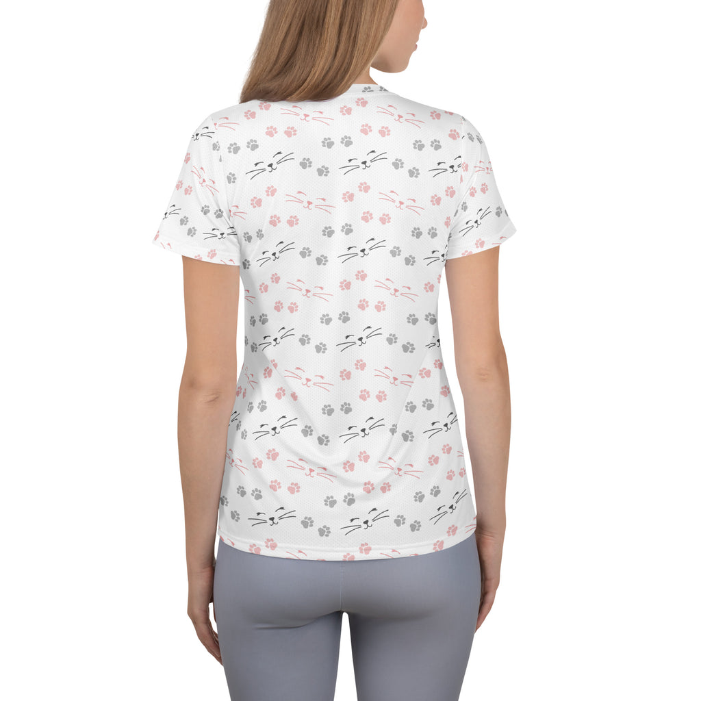 White short-sleeved women’s performance athletic t-shirt with pink and gray cat faces and paw prints, moisture wicking with upf 50+