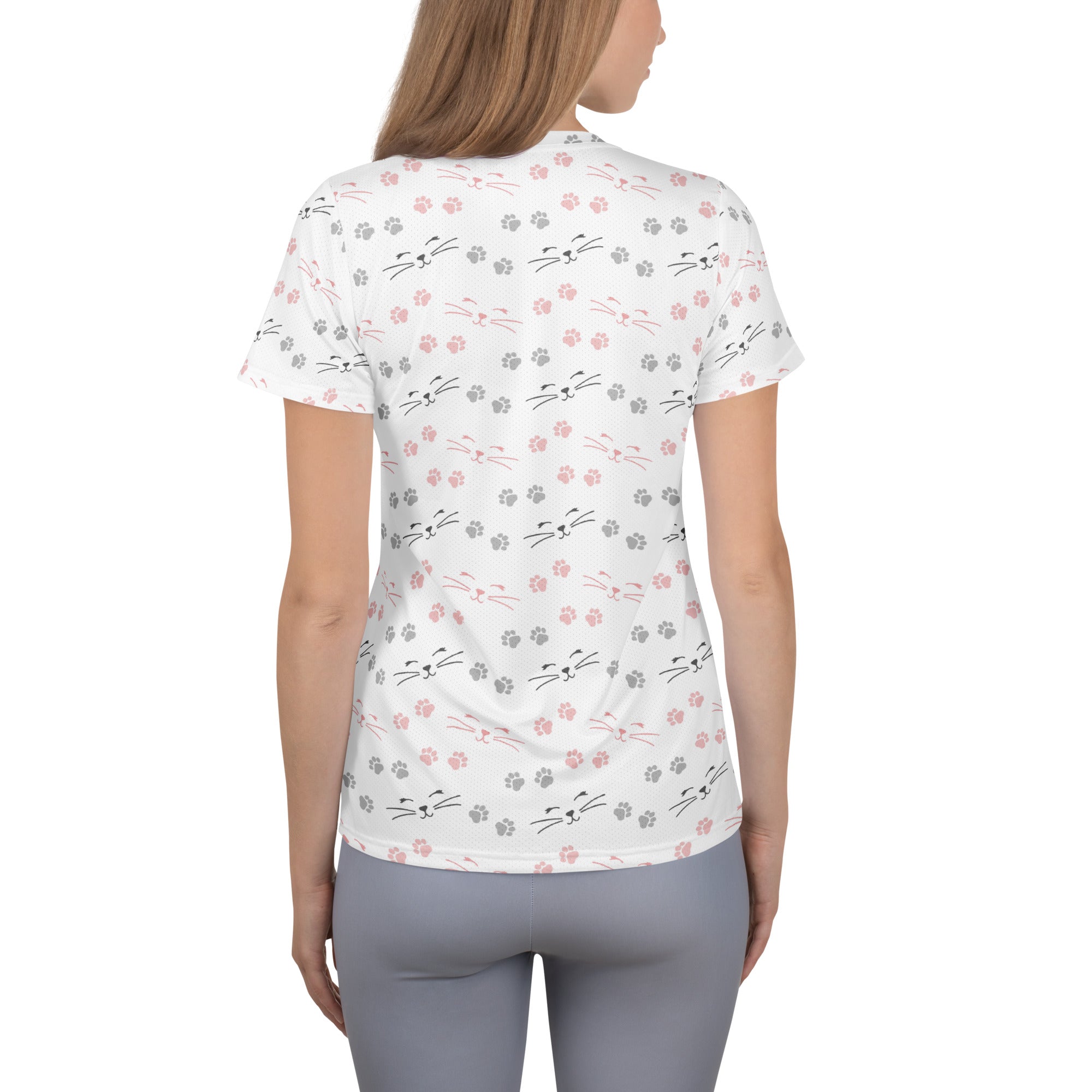 White short-sleeved women’s performance athletic t-shirt with pink and gray cat faces and paw prints, moisture wicking with upf 50+