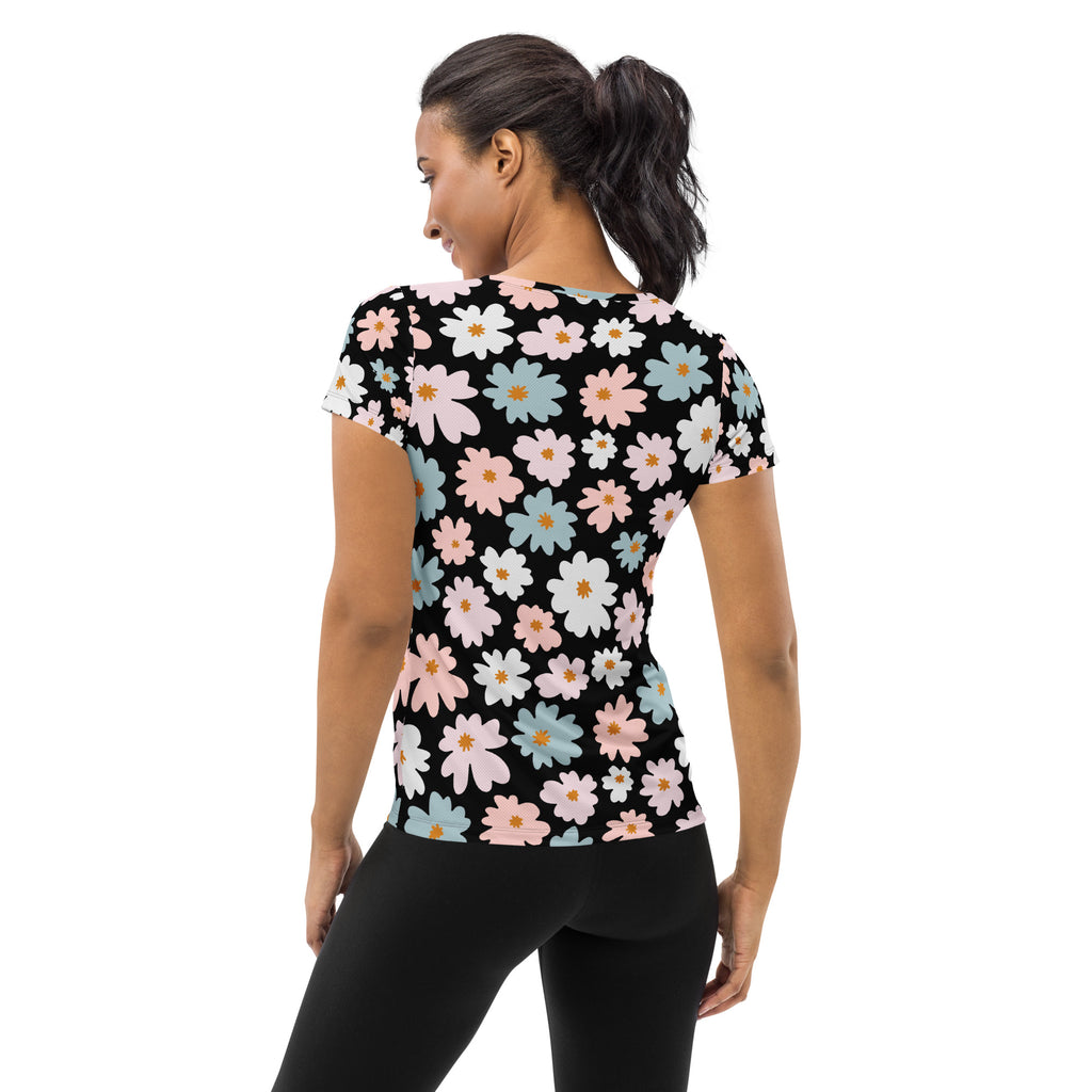 Women’s retro floral performance short-sleeved top in black with pink white and blue daisies, lightweight and moisture wicking