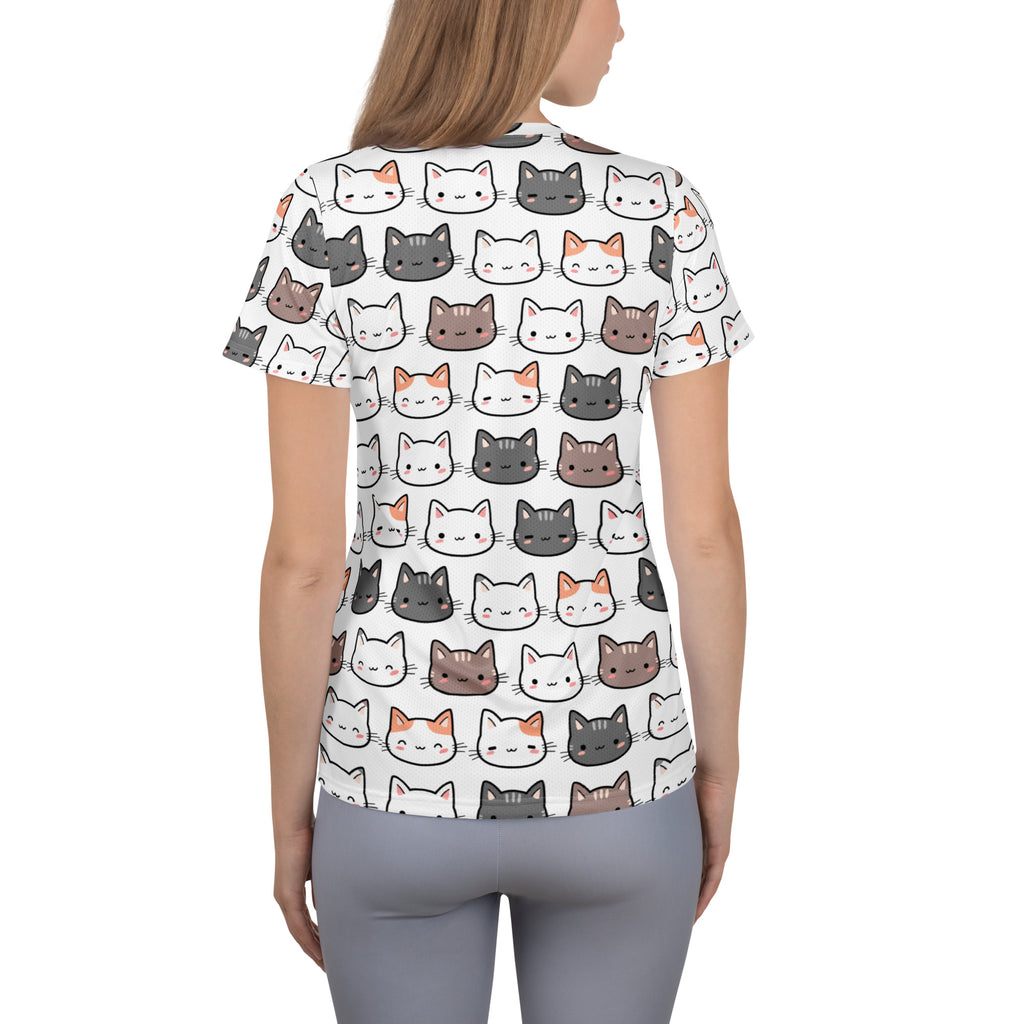 White short-sleeved women’s performance athletic t-shirt with colorful cartoon cat faces and UPF 50 plus moisture wicking fabric
