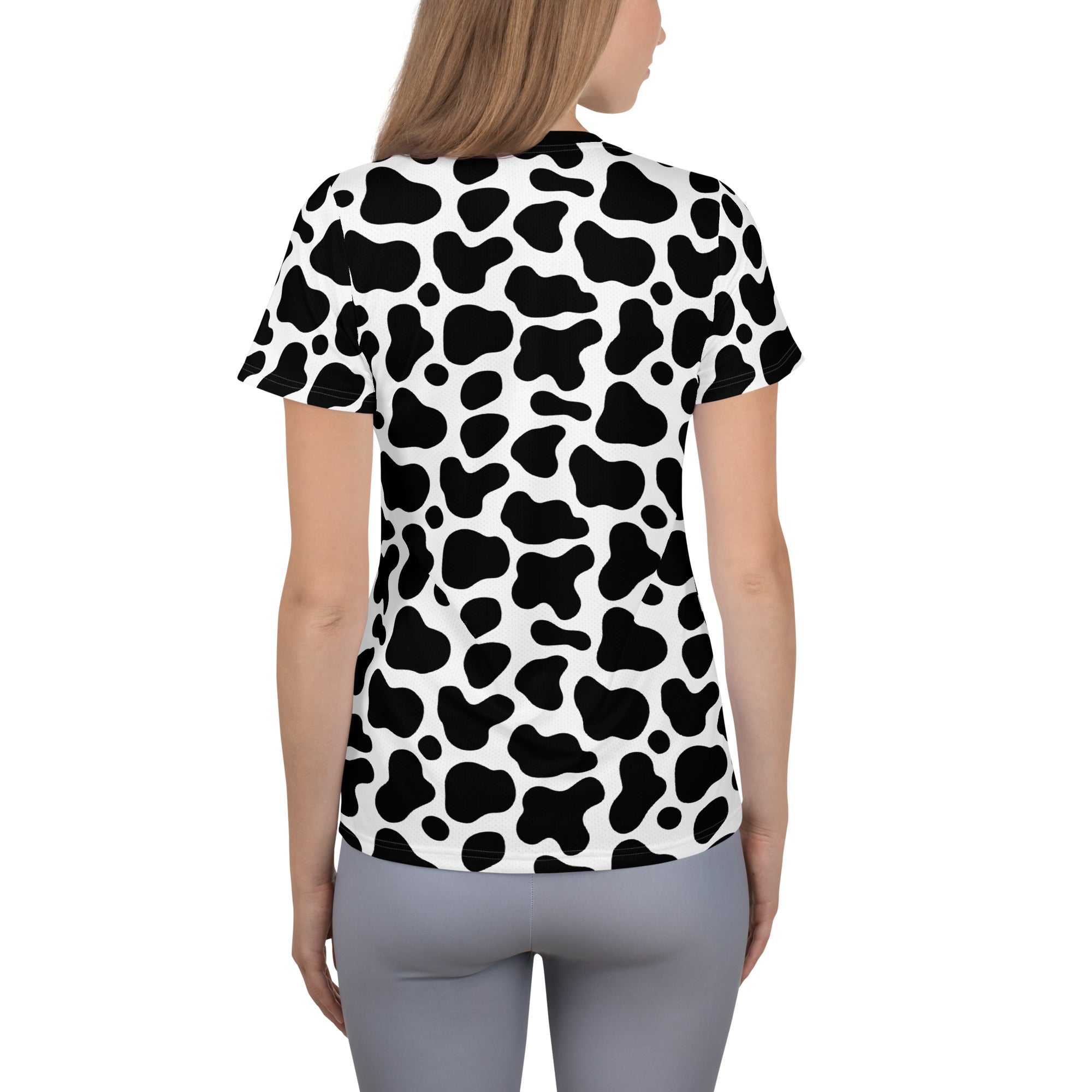 Women’s black and white cow print short-sleeved performance t-shirt with lightweight moisture wicking fabric