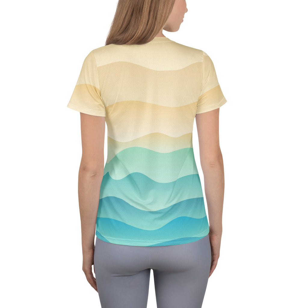 Women’s short-sleeved sand and ocean wave athletic t-shirt with gradient wavy stripes in moisture-wicking fabric