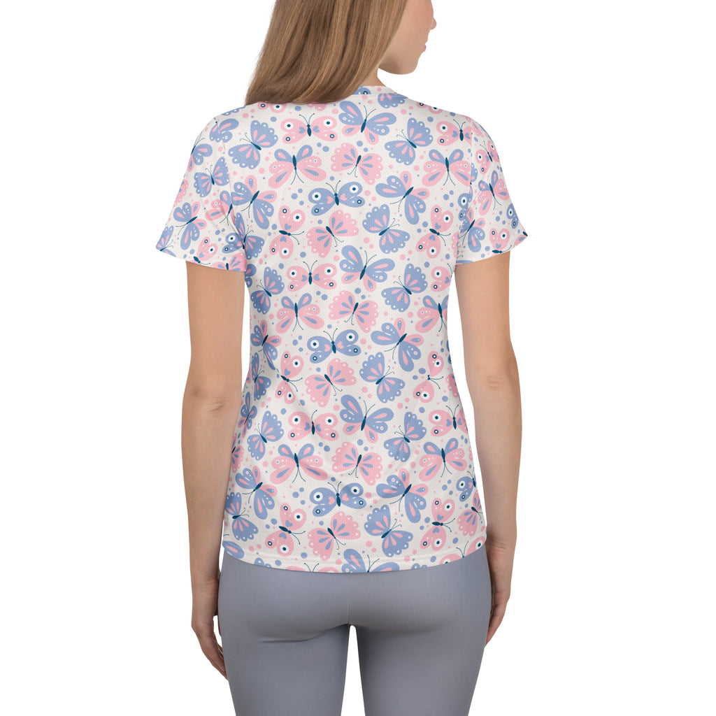 Women’s short-sleeved performance t-shirt with pastel pink and blue butterfly print on white, lightweight and moisture wicking