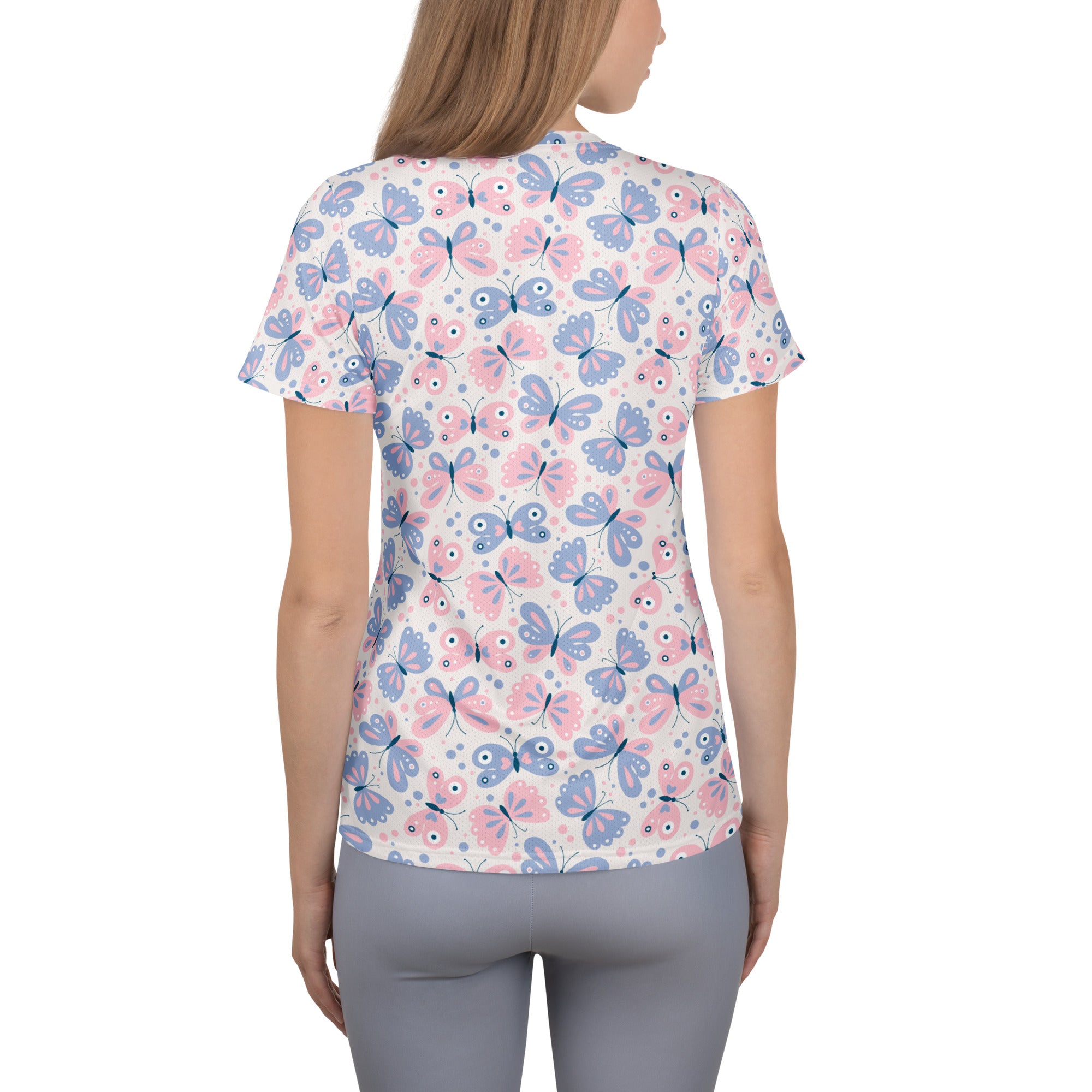 Women’s short-sleeved performance t-shirt with pastel pink and blue butterfly print on white, lightweight and moisture wicking