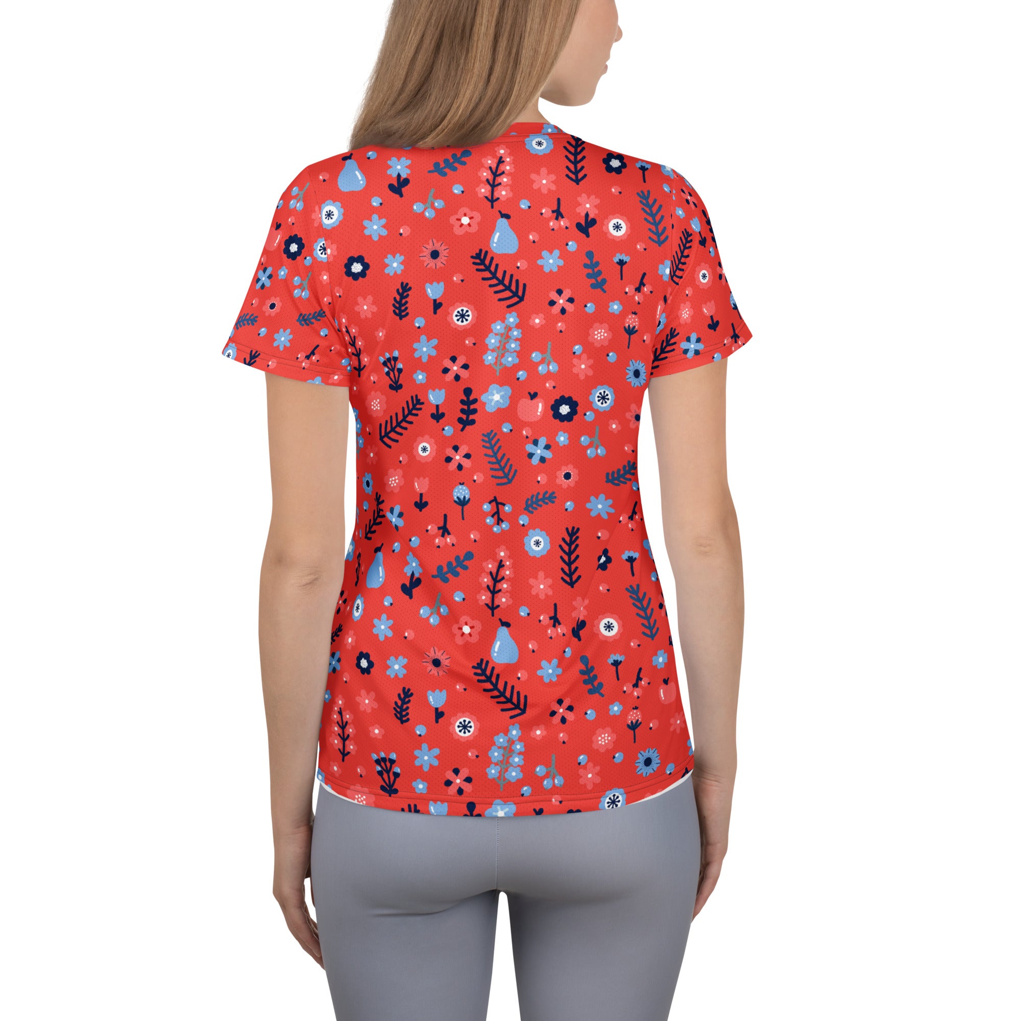 Women’s red floral performance athletic t-shirt with blue and black flowers, lightweight moisture wicking fabric and UPF 50+