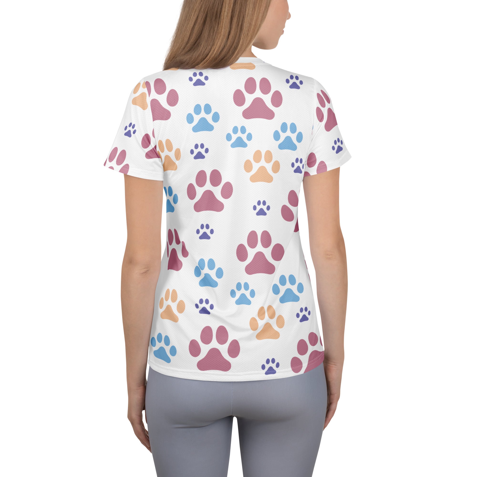 Women’s white short-sleeved performance t-shirt with colorful pink blue and tan paw prints lightweight moisture wicking