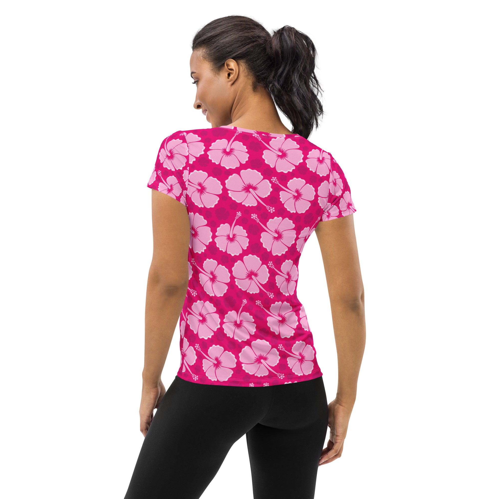 A vibrant pink womens short-sleeved hibiscus performance t-shirt with moisture wicking fabric and UPF 50+ protection