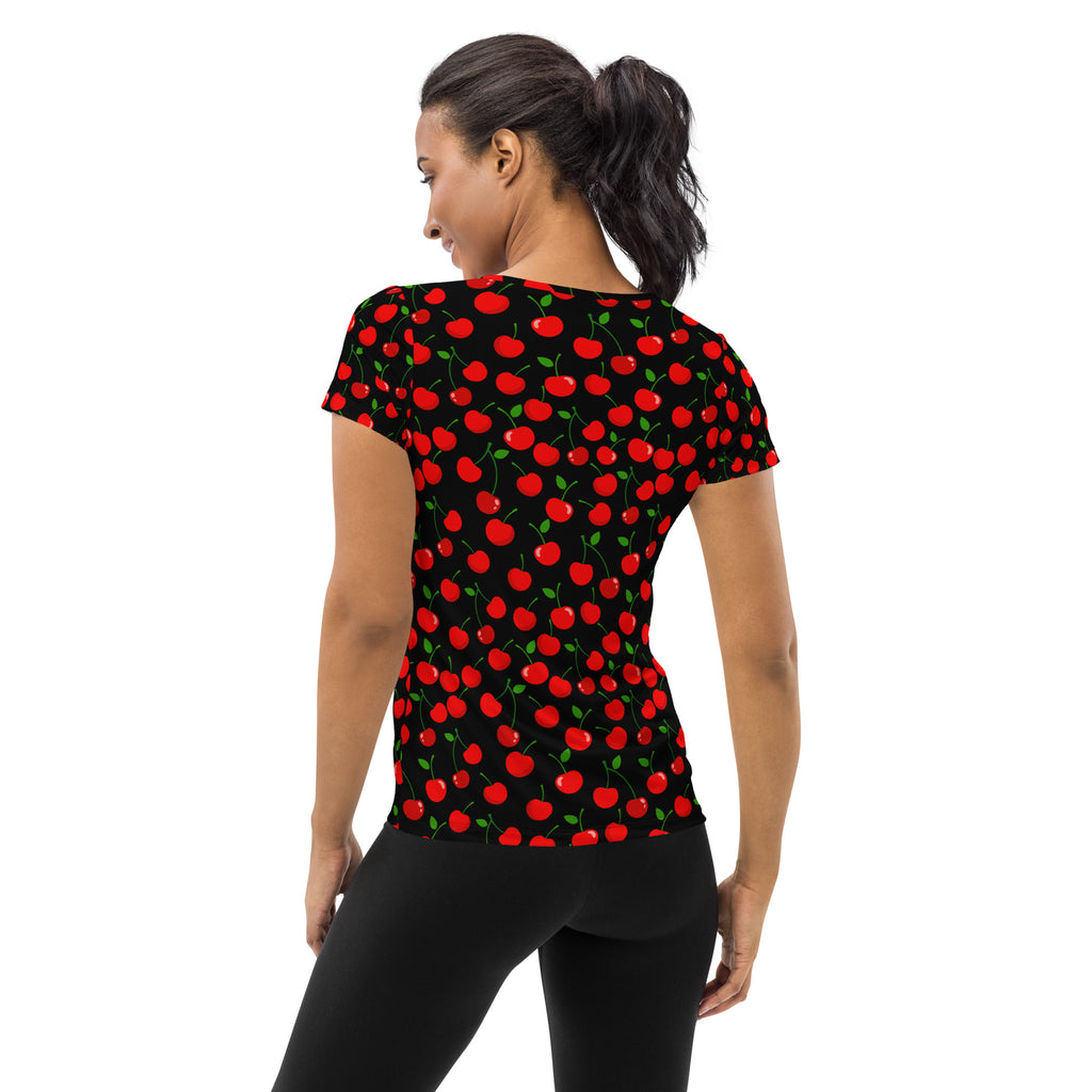 Black short-sleeved women’s athletic t-shirt with vibrant red cherry pattern and green stems, lightweight and moisture wicking