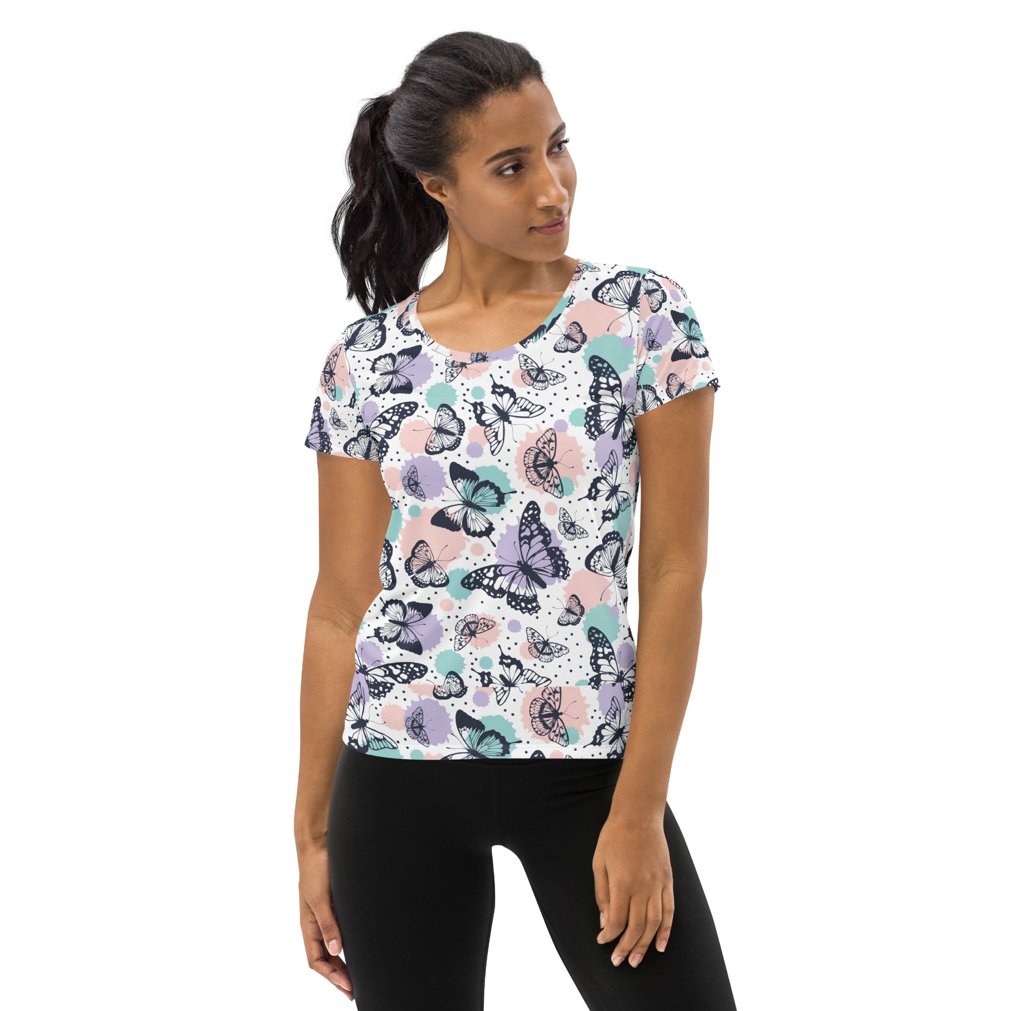 Women’s lightweight moisture wicking butterfly print athletic t-shirt in pastel pink lavender and teal on white background